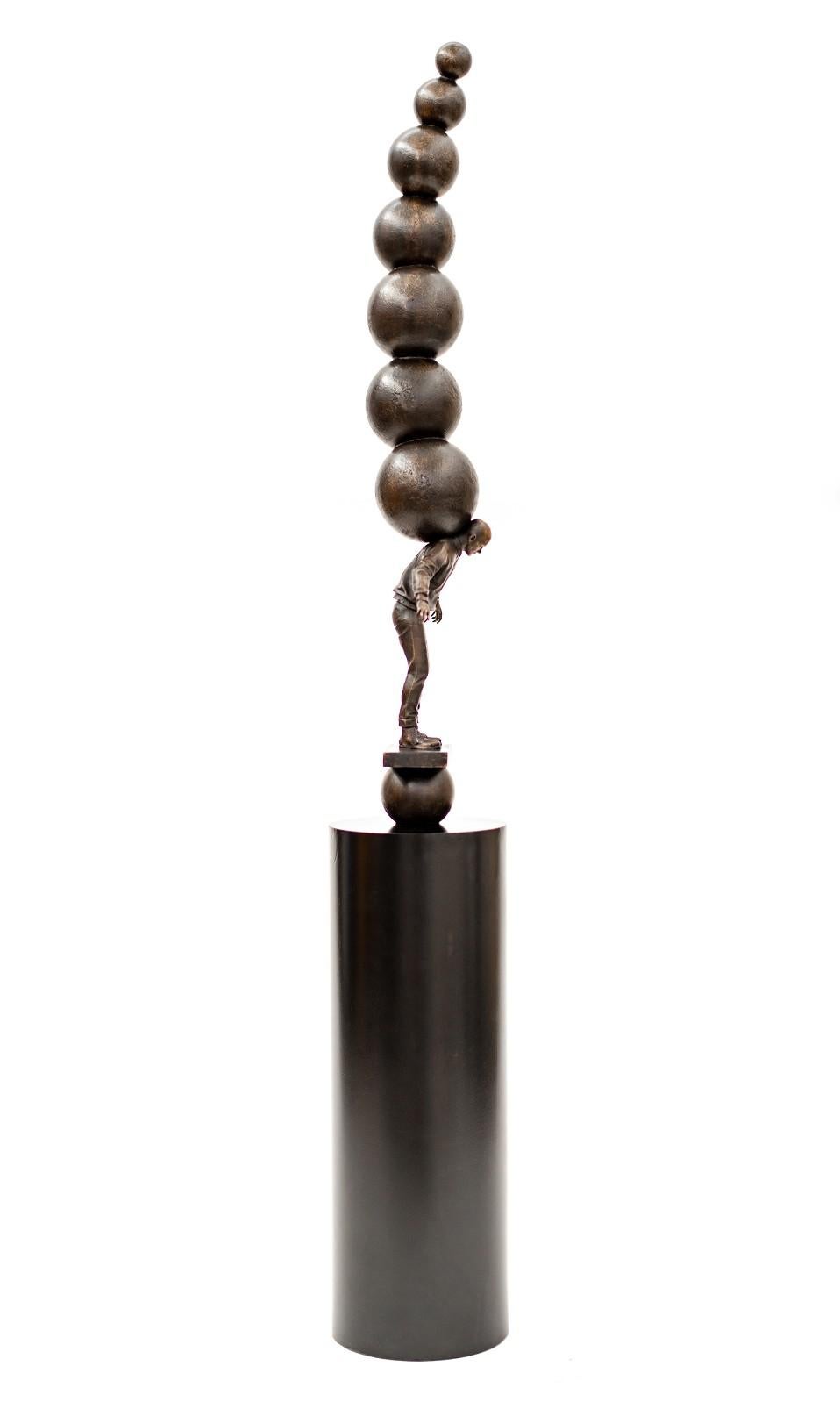 Semblance of Balance - Bronze casted male figure with stacked spheres - Contemporary Sculpture by Roch Smith