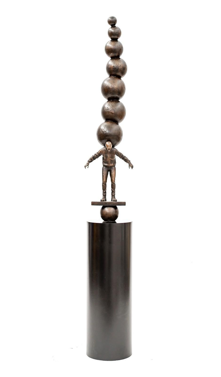 Semblance of Balance - Bronze casted male figure with stacked spheres - Sculpture by Roch Smith