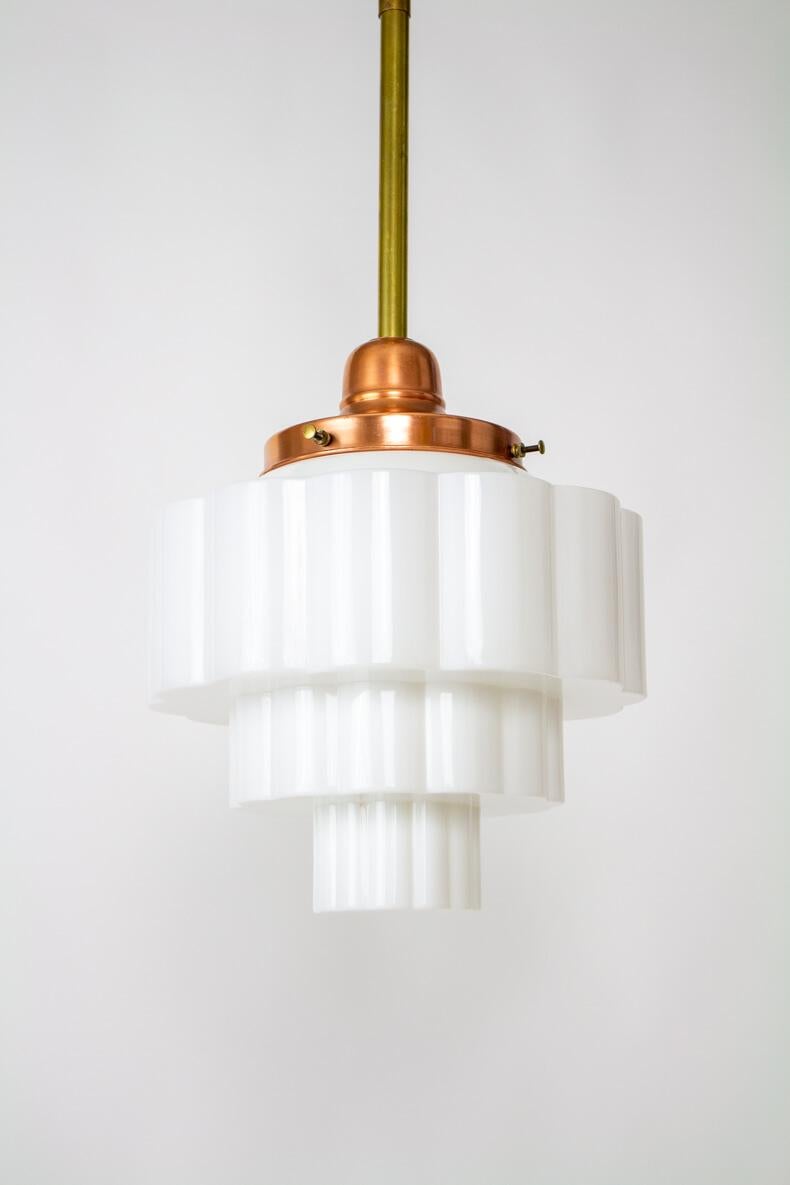 Milk glass Art Deco Skyscraper Pendant Shade on a Copper and brass rod fixture. Rewired and restored. Fixture has swivel and original modernist canopy. Glass fitter is copper and the rod and canopy are brass. Metals have been polished and glass is