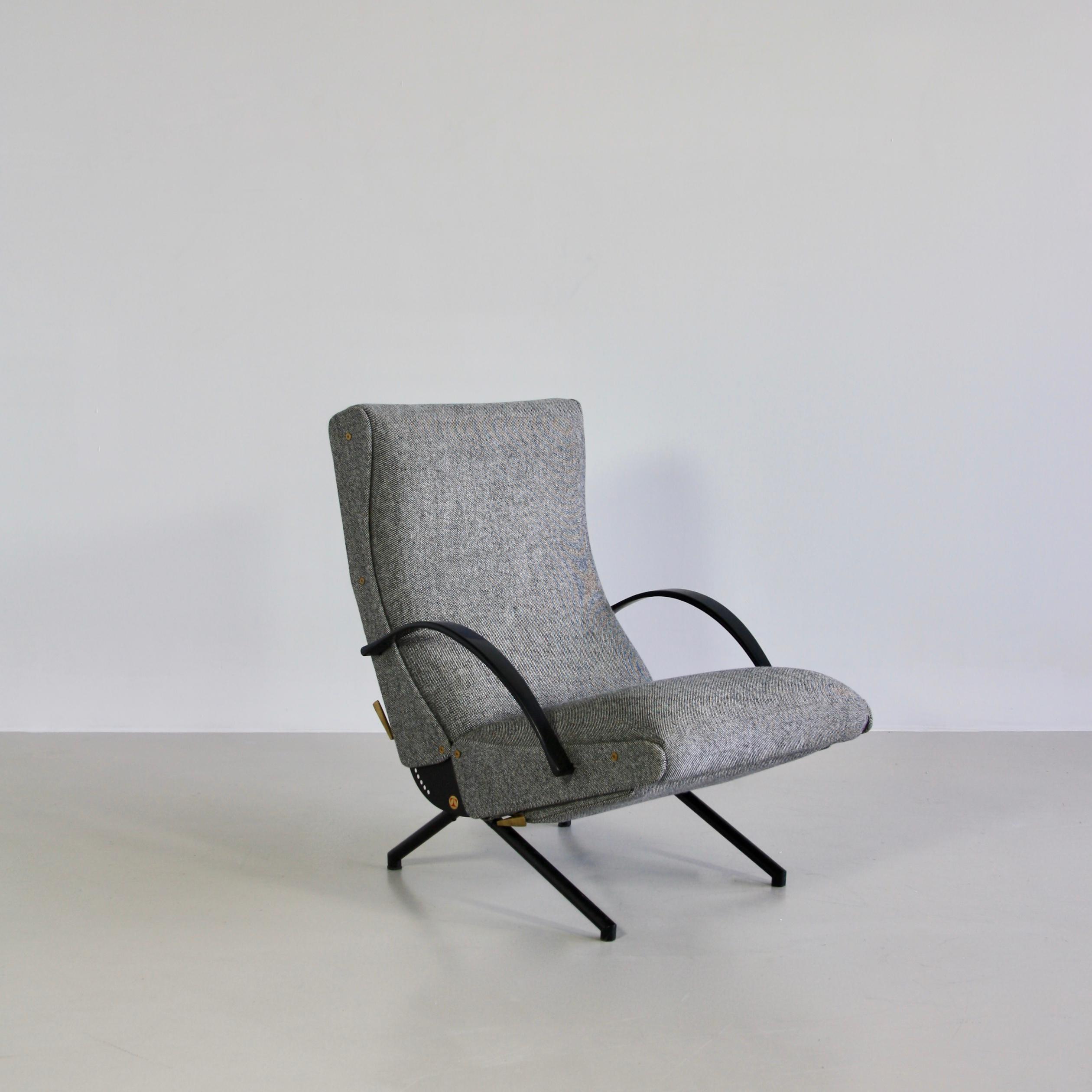 The 'P40' variable tilt armchair, produced by Tecno, Milan 1956. Black tubular frame with rubber armrests. Seat, back and footrest upholstered in yellow wool fabric. The footrest is stored under the seat. Brass detail.

The first edition of this