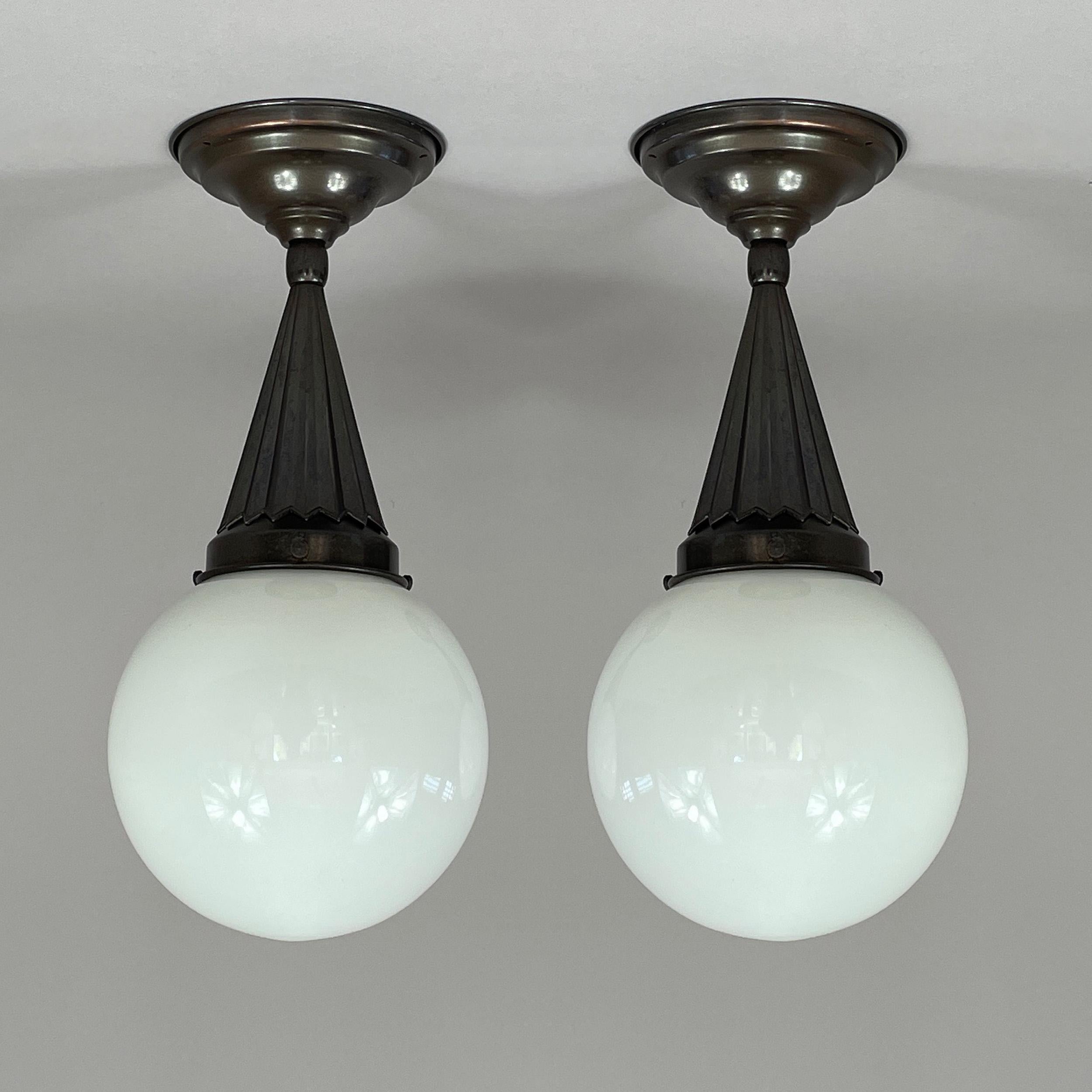 Swedish Grace Opaline Glass & Burnished Brass Flush Mounts / Pendants, Sweden 1940s

The lights feature a striking Swedish Art Deco design, combining geometric elegance with refined craftsmanship. Each flush mount showcases a stepped ceiling canopy
