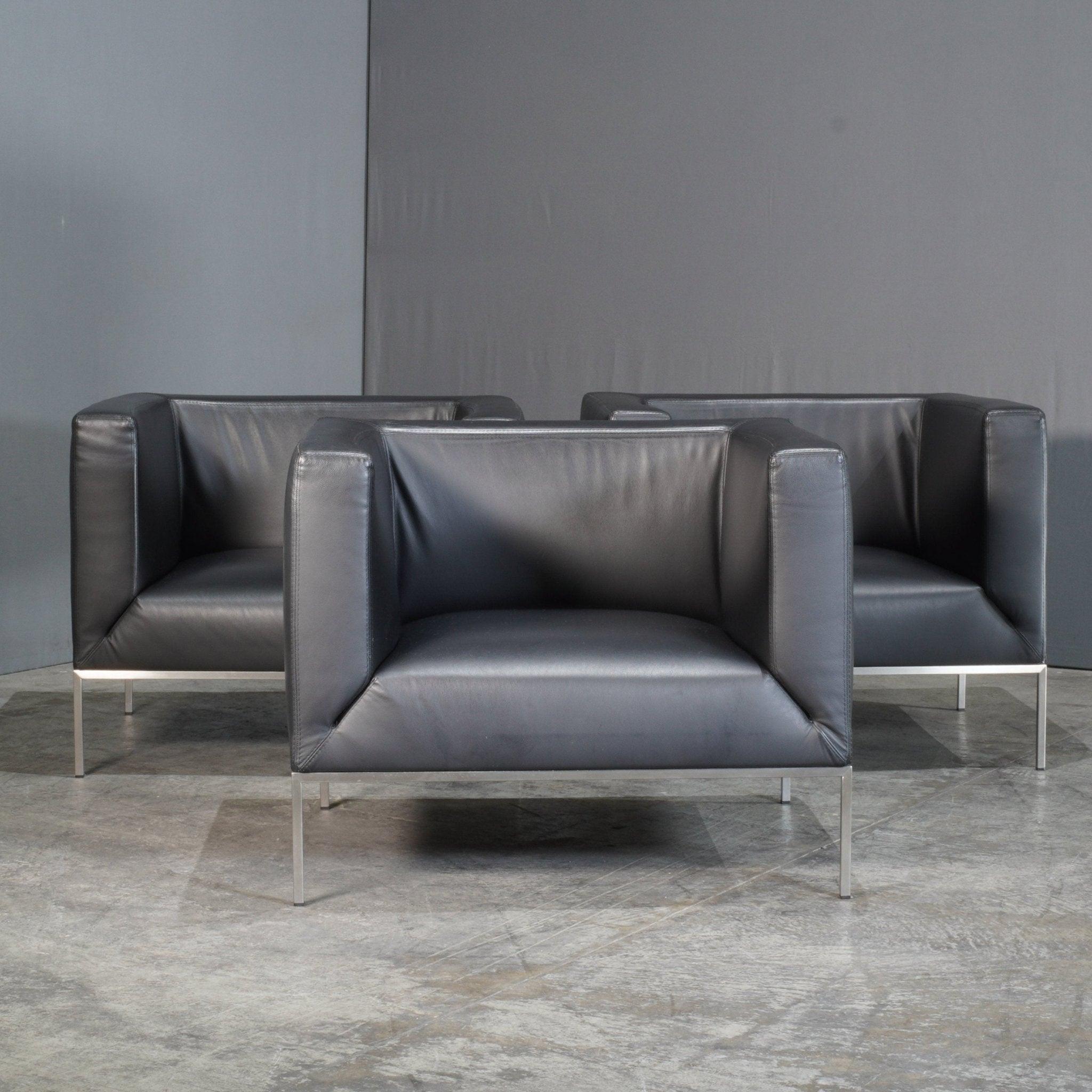 The Paari Design Black Leather Armchair offers a sleek and minimalistic look, designed for modern interiors. Its angular silhouette is complemented by plush, deep cushioning, providing exceptional comfort. Upholstered in premium black leather, the