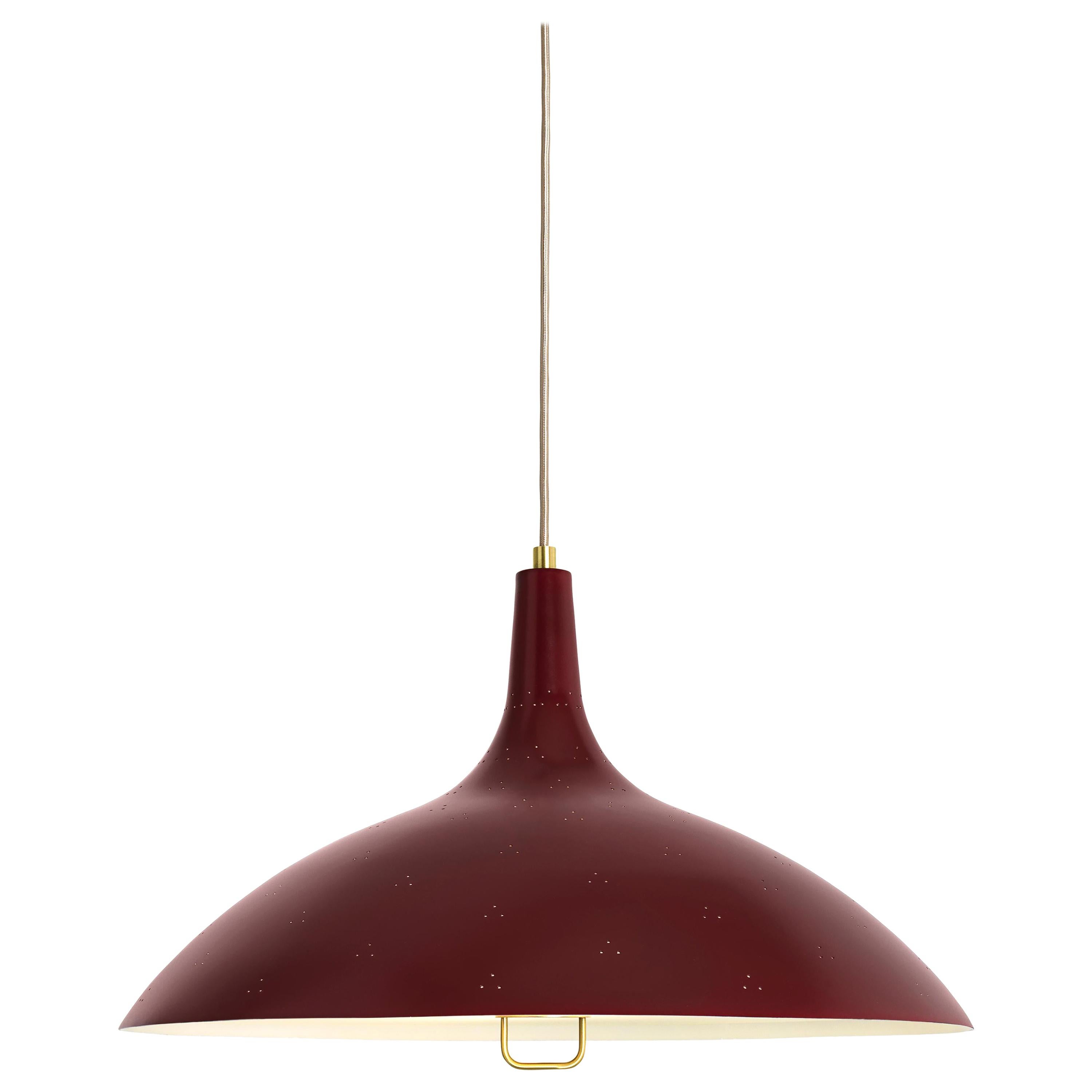 Paavo Tynell '1965' pendant lamp in red. Originally designed by Paavo Tynell in 1947, this authorized GUBI re-edition is executed in a perforated brass metal shade with white interior and glass diffuser. Like many of his iconic designs, the pendant