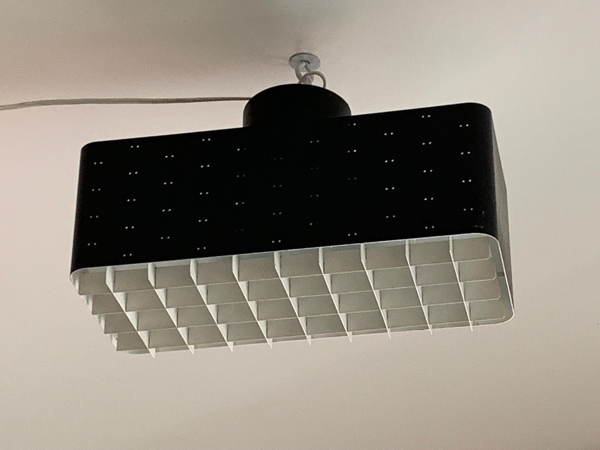 A rare Paavo Tynell 9068, rectangular light in original black/white color configuration. Flush mount with twin portholes allowing a beautyful light projection. Added by a white grid and glass diffuser. Manufactured by Idman, this example is a real