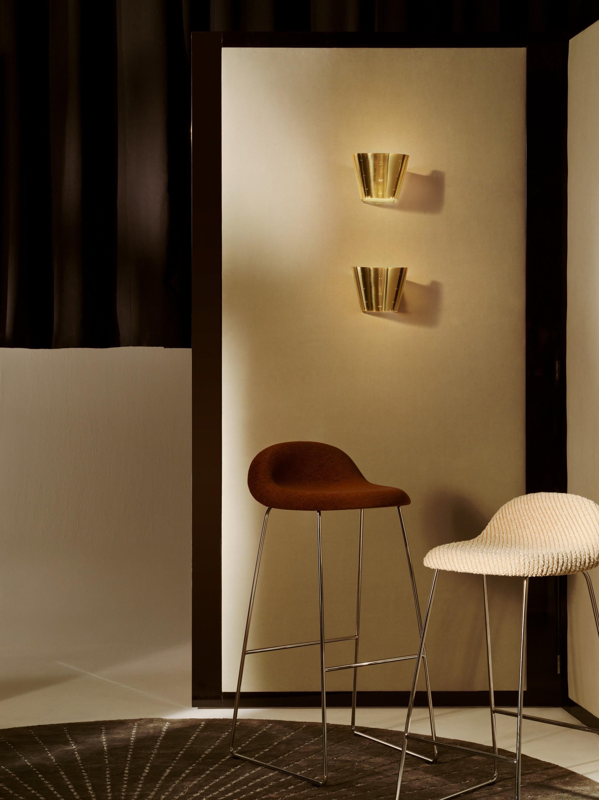 The 9464 Wall Lamp, designed in the early 1950s by Paavo Tynell, is a great example of how the Finnish designer elevated illumination into an art form. The clean, sculptured brass shade lends an air of elegance with Tynell’s distinctive traits of