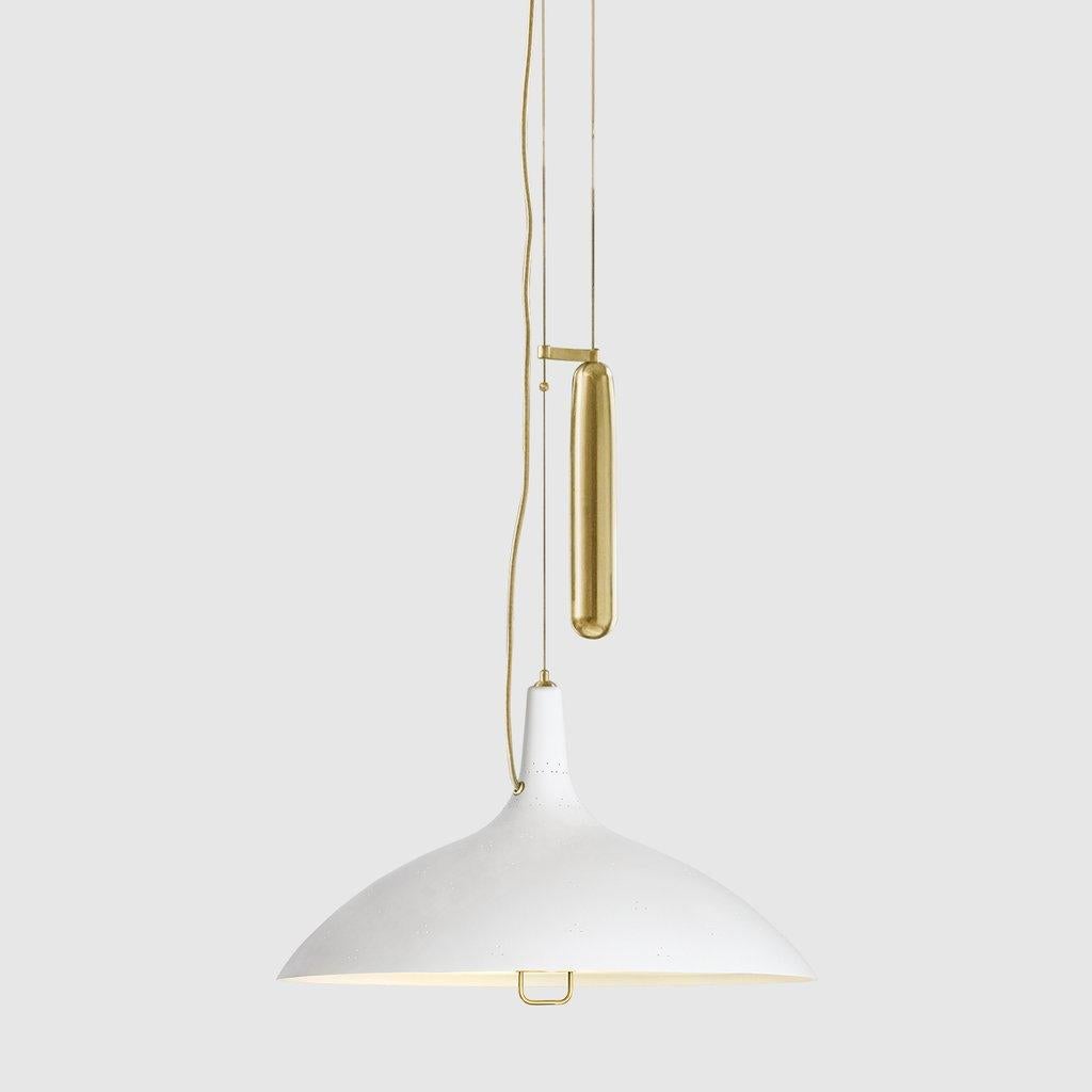 Paavo Tynell 'A1965' counterweight pendant lamp in white. Originally designed by Paavo Tynell in 1947, this authorized GUBI re-edition is executed in a perforated brass metal shade with white interior and glass diffuser. Like many of his iconic