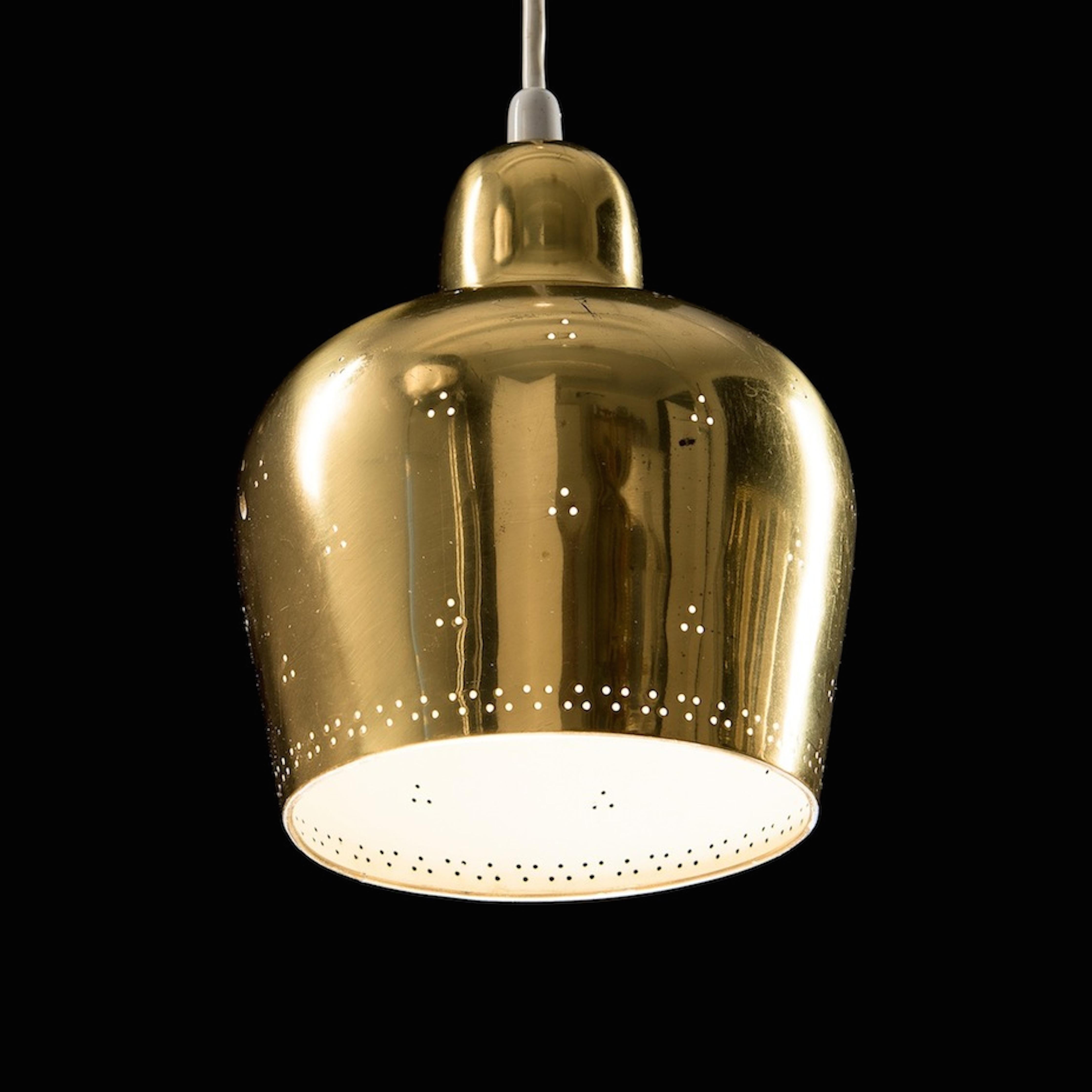 A polished and perforated brass pendant light designed jointly by Paavo Tynell and his pupil, Alvar Aalto and edited by Taito Oy in the 1940s. A collection piece.
 