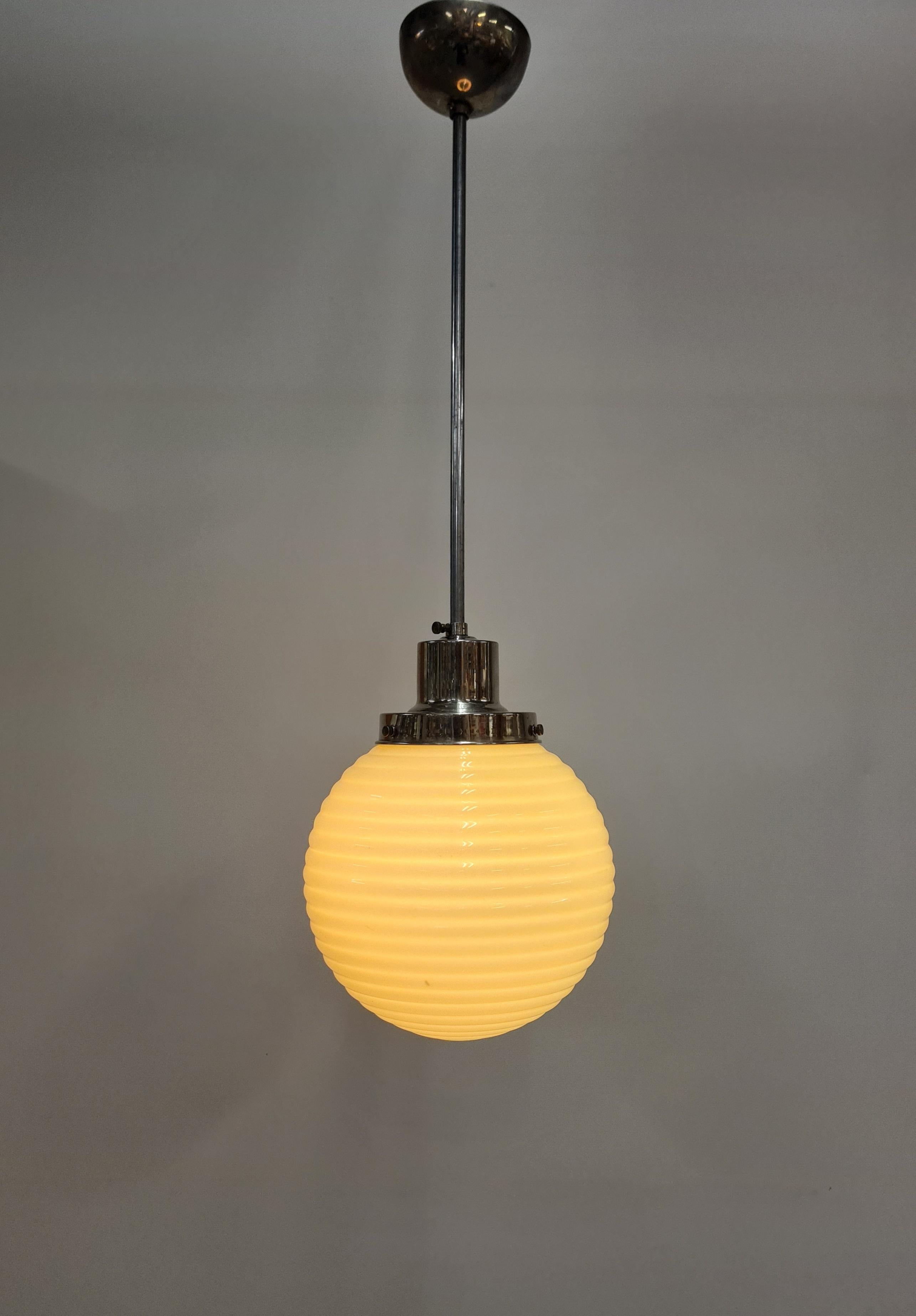 A beautiful art deco Paavo Tynell lamp in nikkled brass with a cream colour wavy surfaced opaline glass  shade. The lamp model is 1601 featured in one of the 1930s catalogues. Perfect for kitchens, small spaces or as a side lamp. According to the