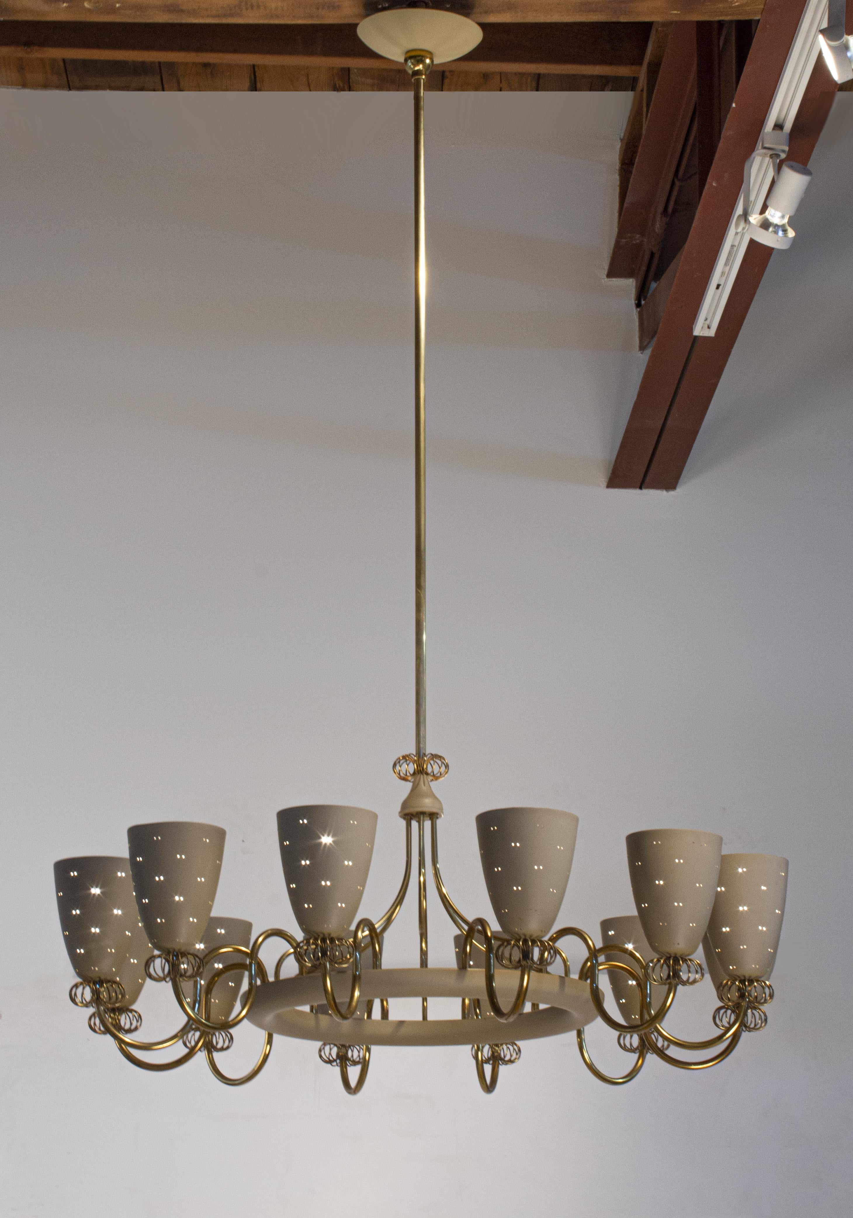 Extraordinary Paavo Tynell Ballerina Chandelier was designed in the 1960s and produced by Lightolier for the American market. Consists of 12 perforated spun aluminum shades in the original flat beige lacquered finish. Elegant from every angle.
