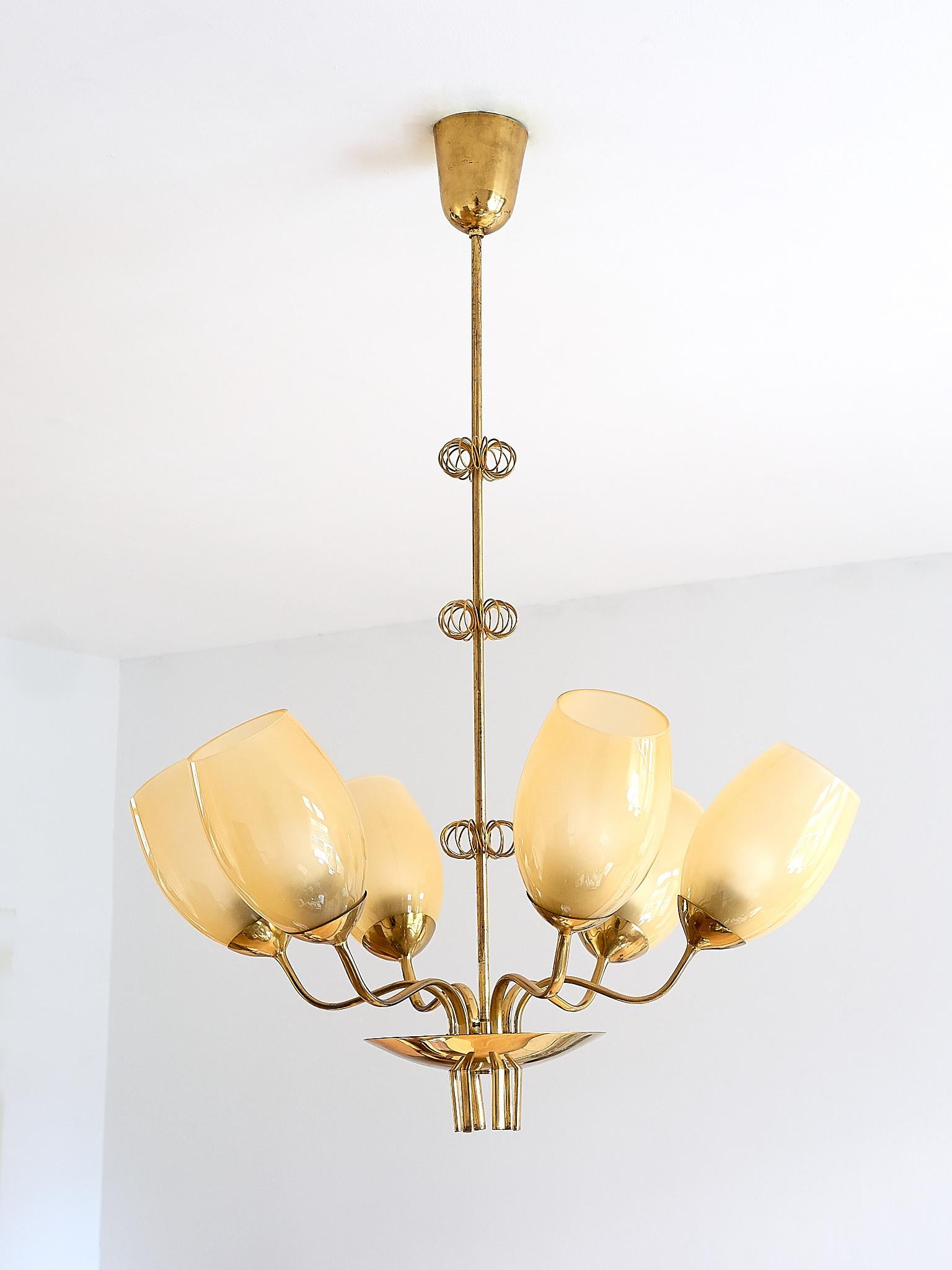 This six-glass chandelier was designed by Paavo Tynell and produced by Taito Oy in Finland in 1949. Paavo Tynell was responsible for designing the lighting for the hospital in Kuopio, which can be viewed in the sketches from the Taito archives (as