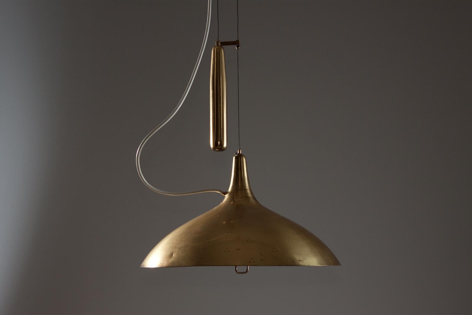 The Paavo Tynell brass counterweight light A1965 for TAITO Oy is a stunning addition to any interior design. With its iconic design and high-quality brass finish, this light fixture adds a touch of elegance and sophistication to any space. The