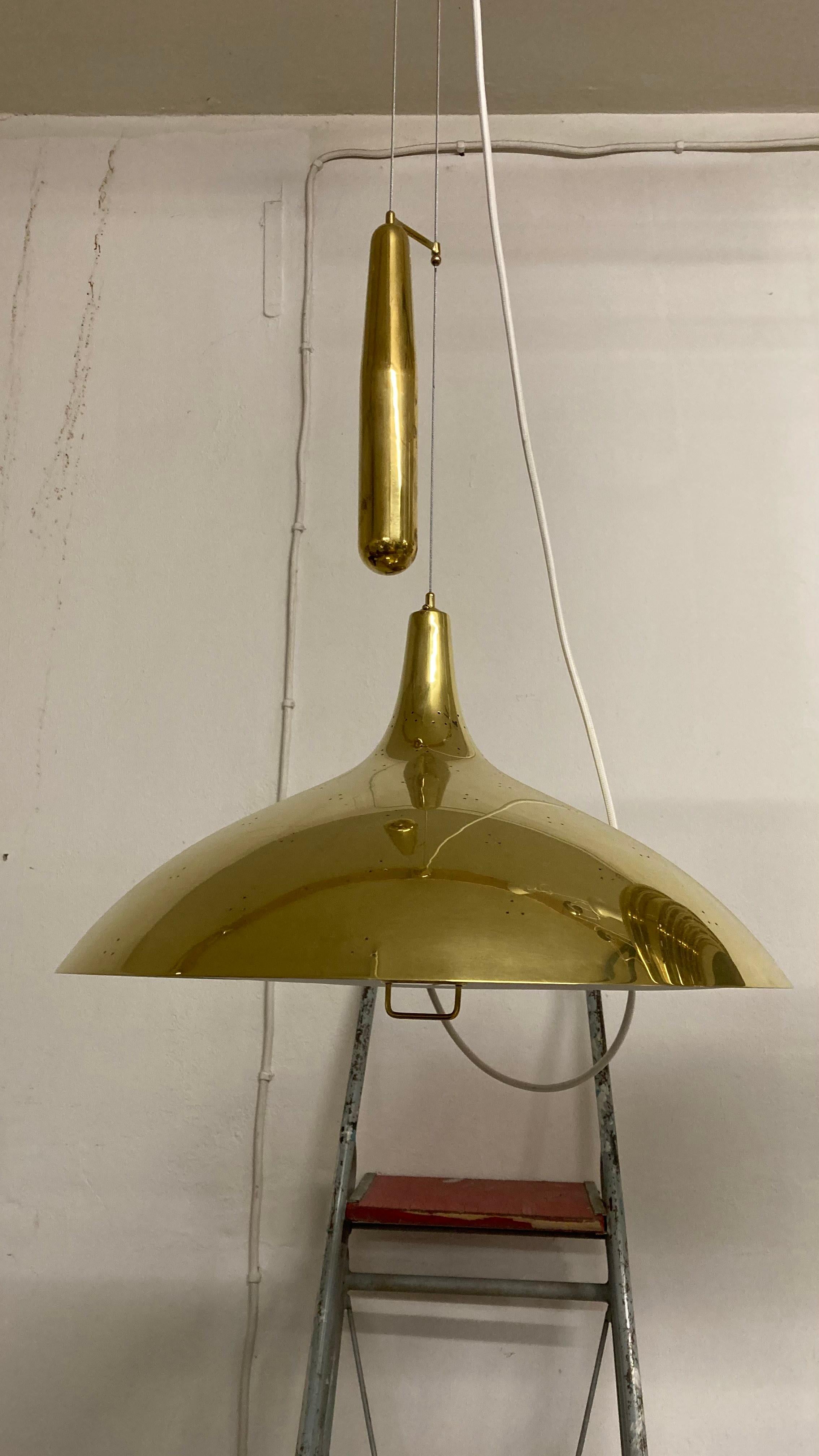 The Paavo Tynell brass counterweight light A1965 for TAITO Oy is a stunning addition to any interior design. With its iconic design and high-quality brass finish, this light fixture adds a touch of elegance and sophistication to any space. The