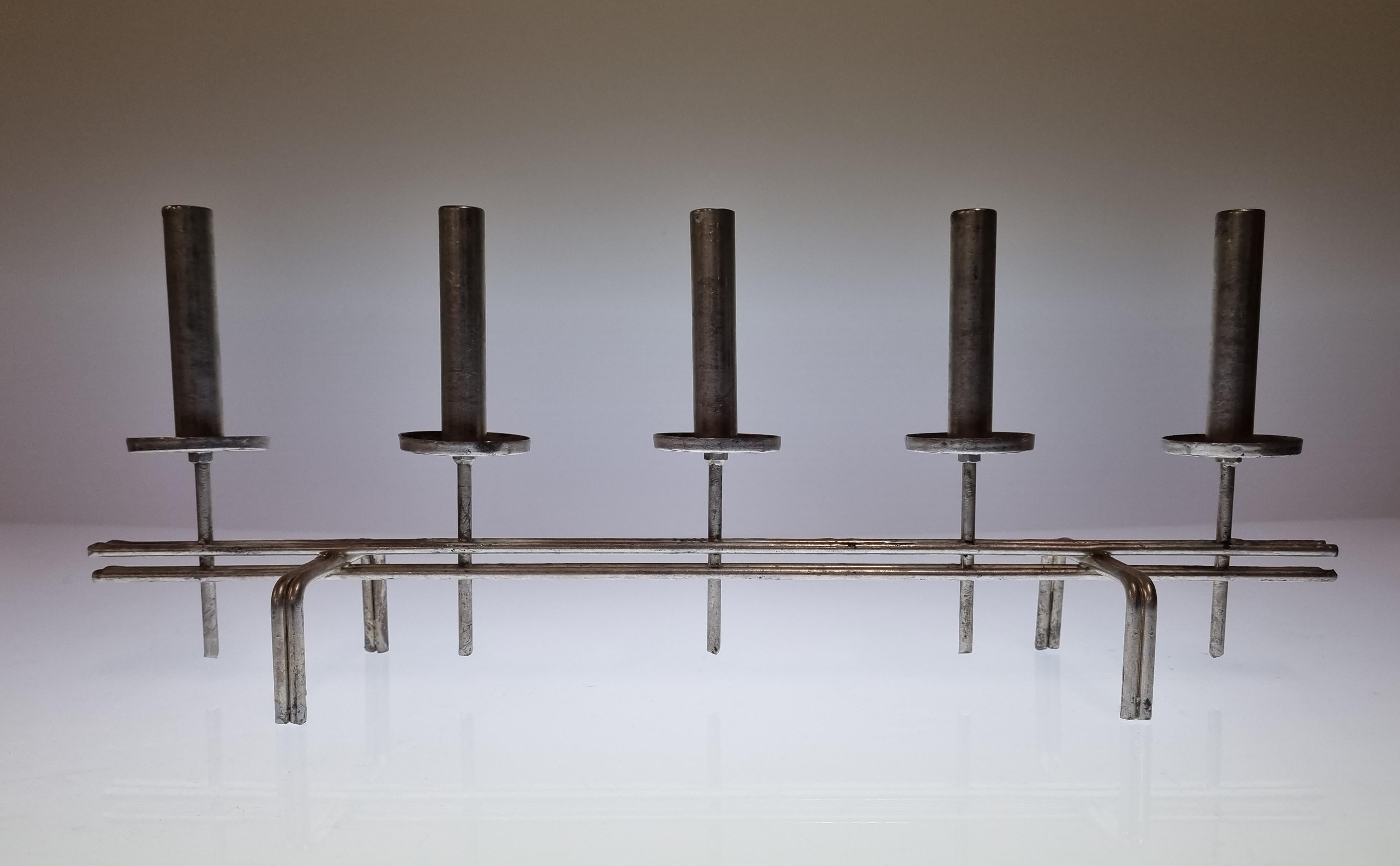 In addition to his iconic brass lamps, Paavo Tynell (1890-1973) designed candle holders and othe metal items. This candle holder is such an example and was handmade late in his career by Paavo Tynell himself. After retiring from making lamps, Tynell