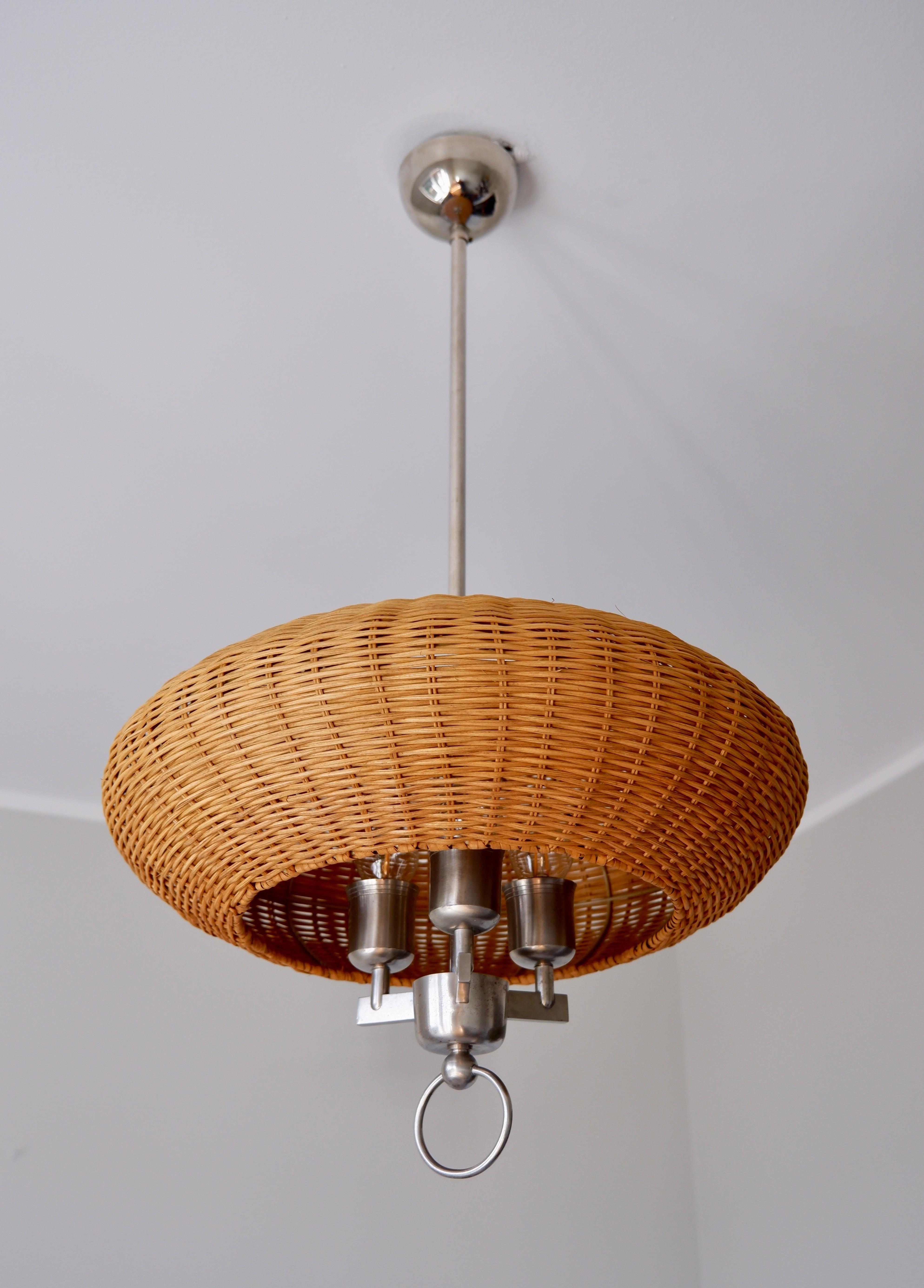 Paavo Tynell ceiling lamp made by Taito in the 40s. The lamp is made in Nikel plated brass with a wood strip shade which has been replace from the original shade after restoration. This model is one of the first ever design by Paavo Tynell during