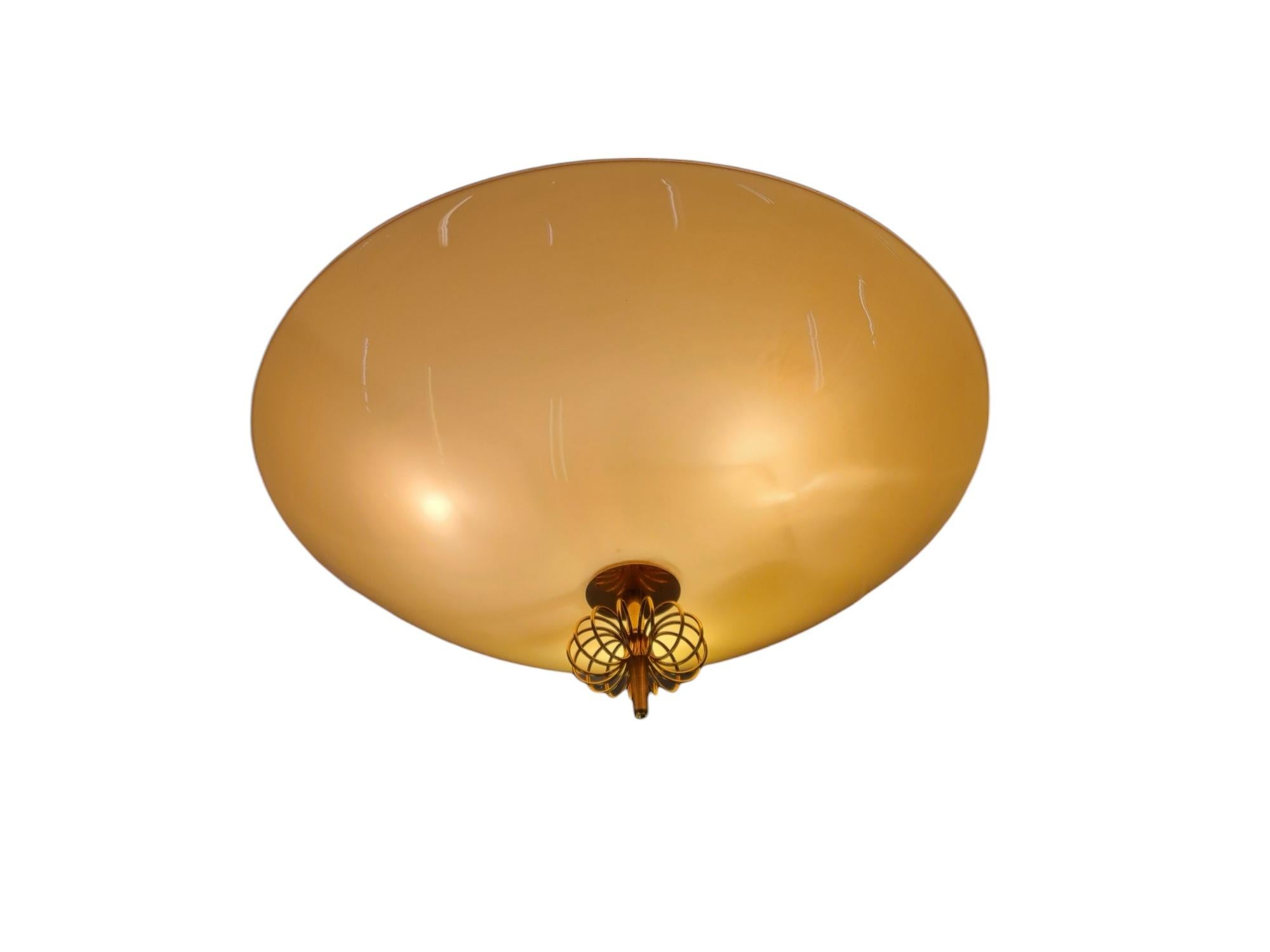 A beautiful ceiling lamp by Paavo Tynell. This model came with different size glass version shades, mainly 40 , 50 or 60 cm long. 
This patrticular example is in completely original condition. The vanilaor off white colored glass as well. 
This lamp