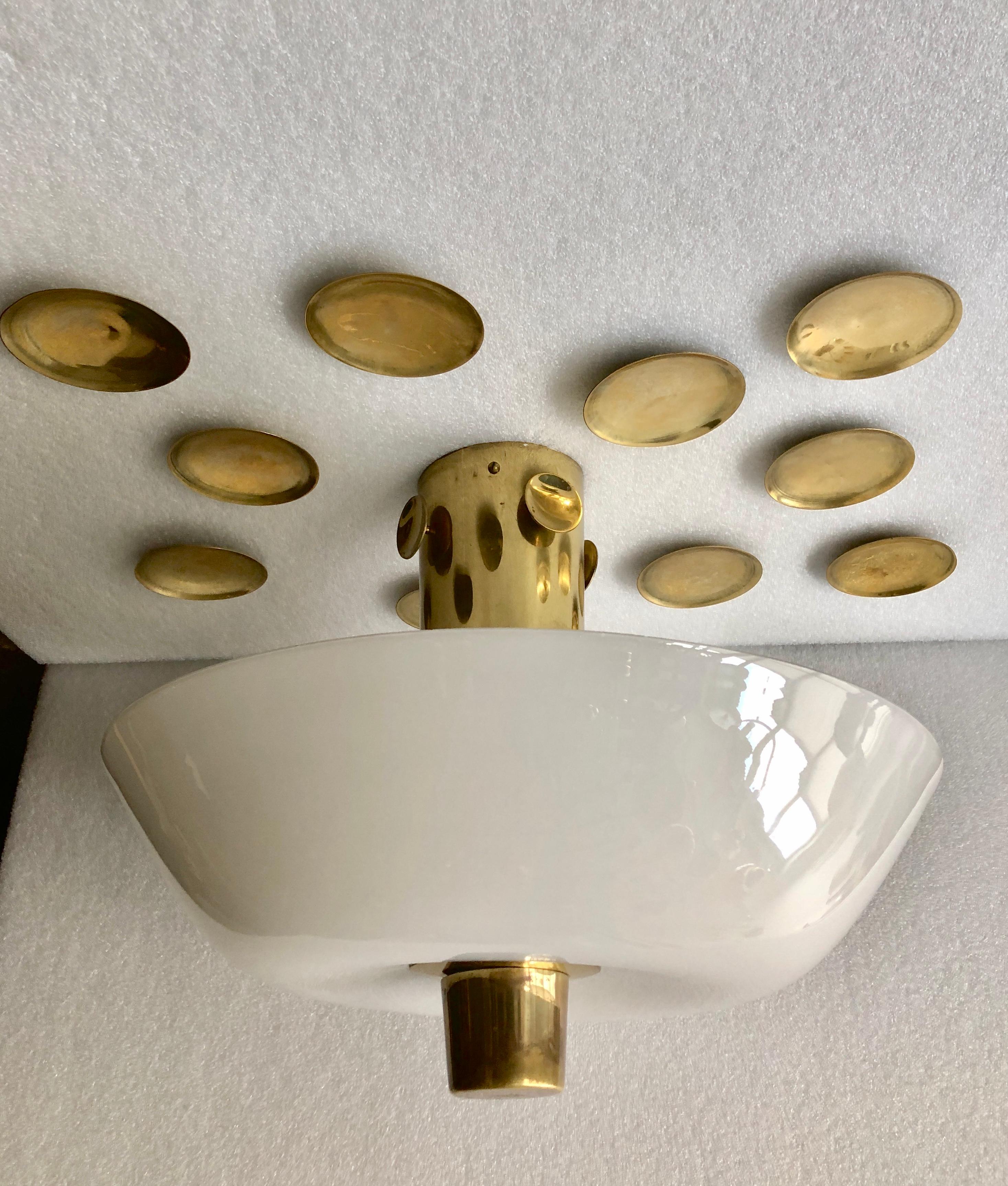 Rare available ceiling light with polished brass ceiling mount reflectors. Model #8052, designed by Paavo Tynell for Taiot/ Idman, Finland , Circa 1950th. Polished brass with opaline glass reflector. 
Similar example at catalogue Idman Lighting
