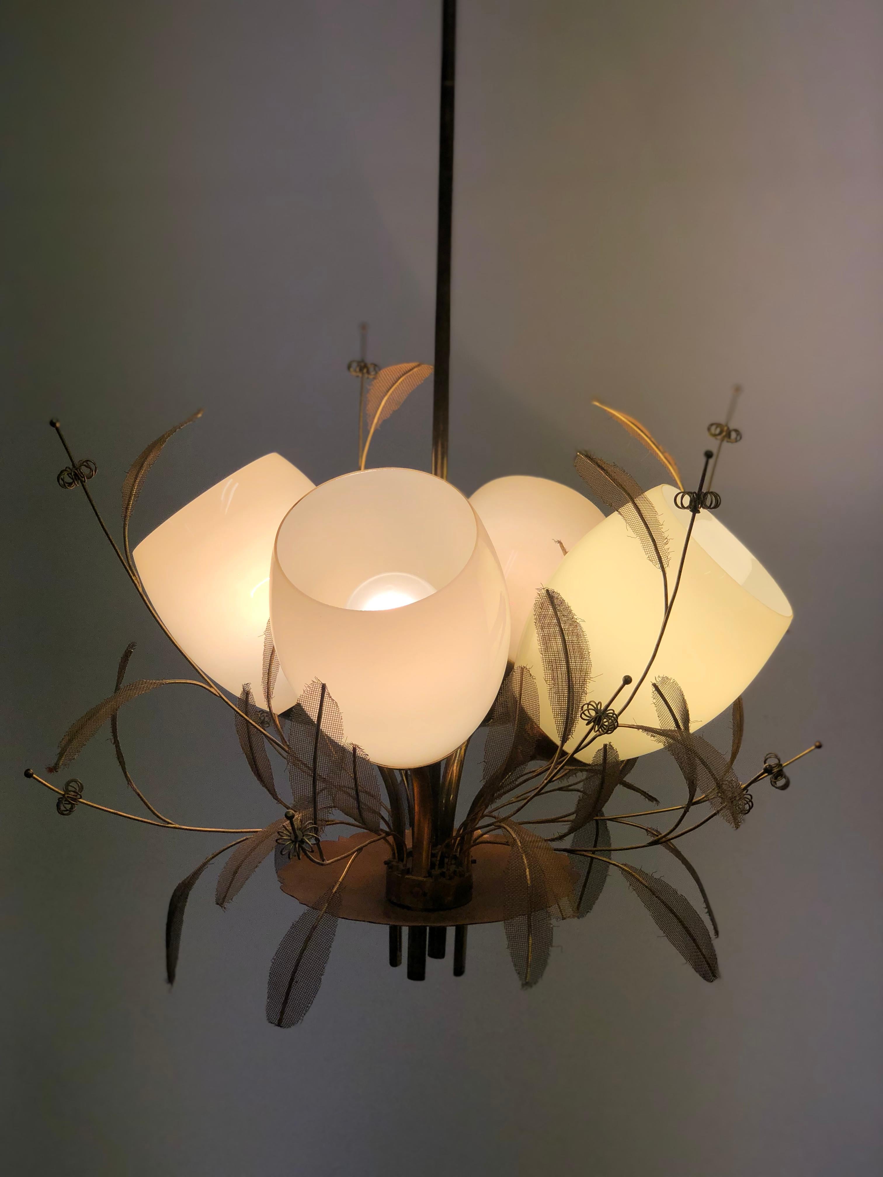 The classic 9029 chandelier by Paavo Tynell was made in various different sizes. This particular one is the one with four shades. Some refer to it as the 