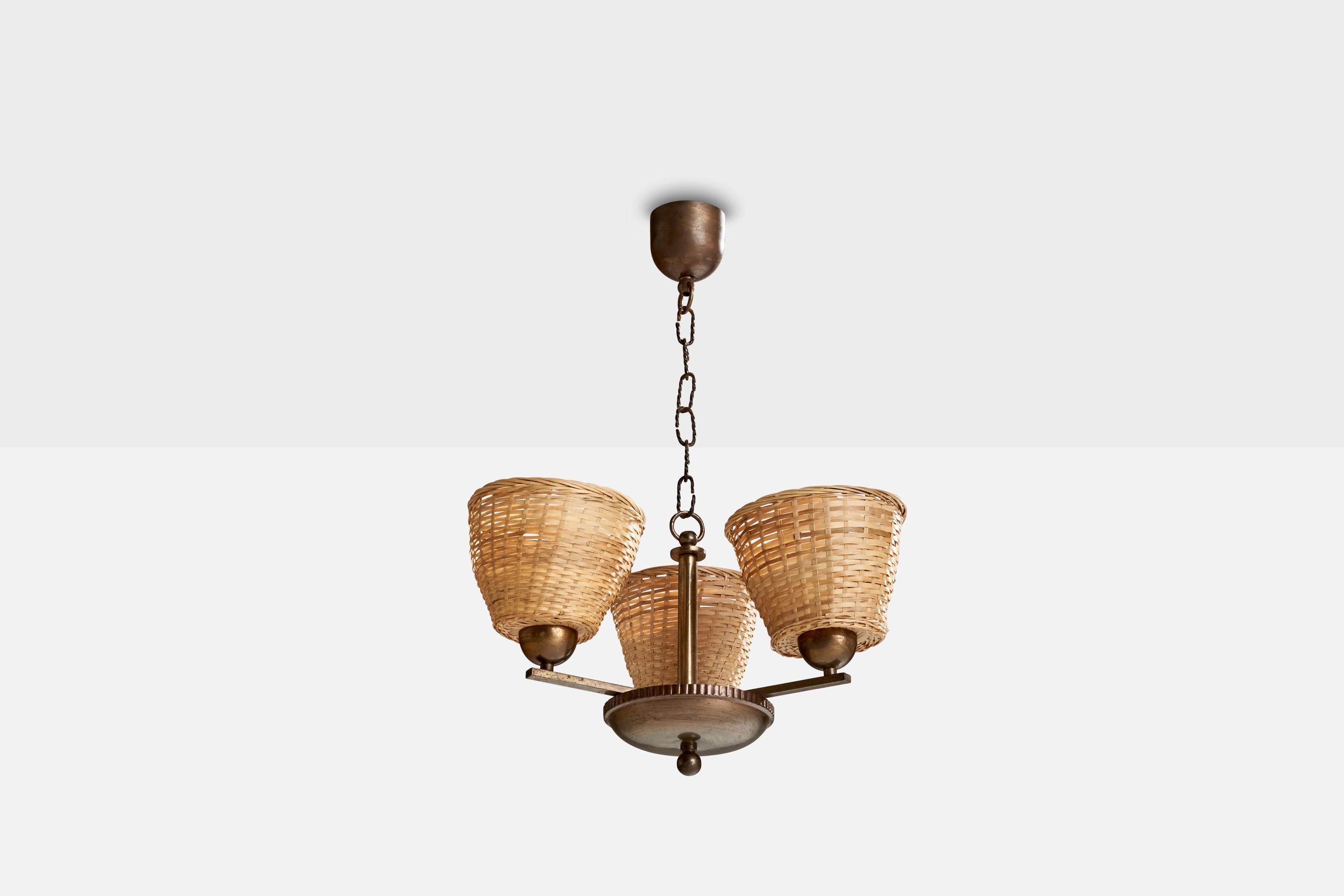 A brass and rattan chandelier, model 1409/3, designed by Paavo Tynell and produced by Taito, Finland, c. 1930s.

Dimensions of canopy (inches): 3.29” H x 3.86” Diameter
Socket takes standard E-26 bulbs. 3 socket.There is no maximum wattage stated on