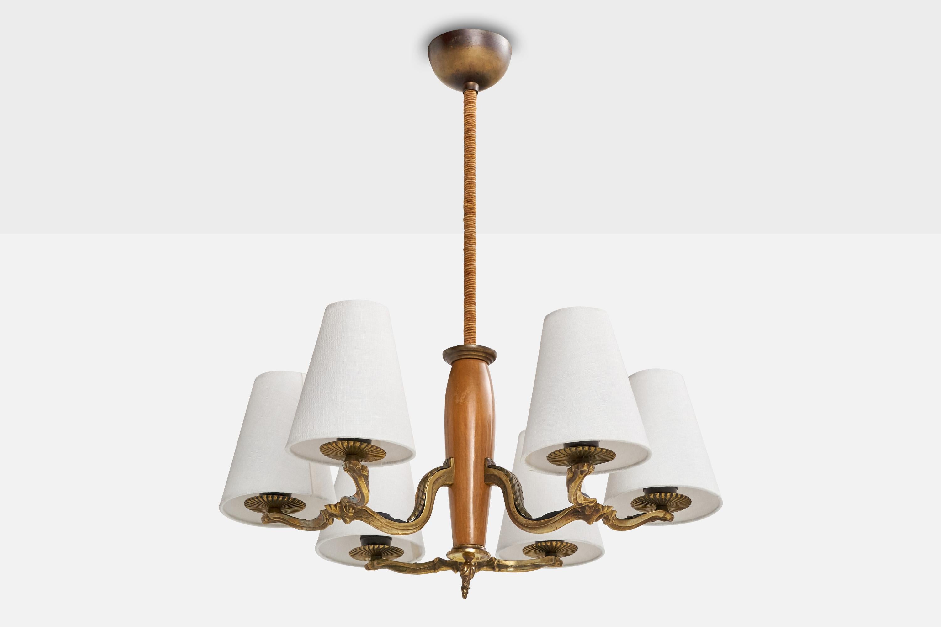 A brass, fabric, cord and wood chandelier, model 1855, designed by Paavo Tynell and produced by Taito OY, Finland, c. 1930s.

With brand new fabric lampshades. Originally mounted with glass diffusers.

Overall Dimensions (inches): 26.625