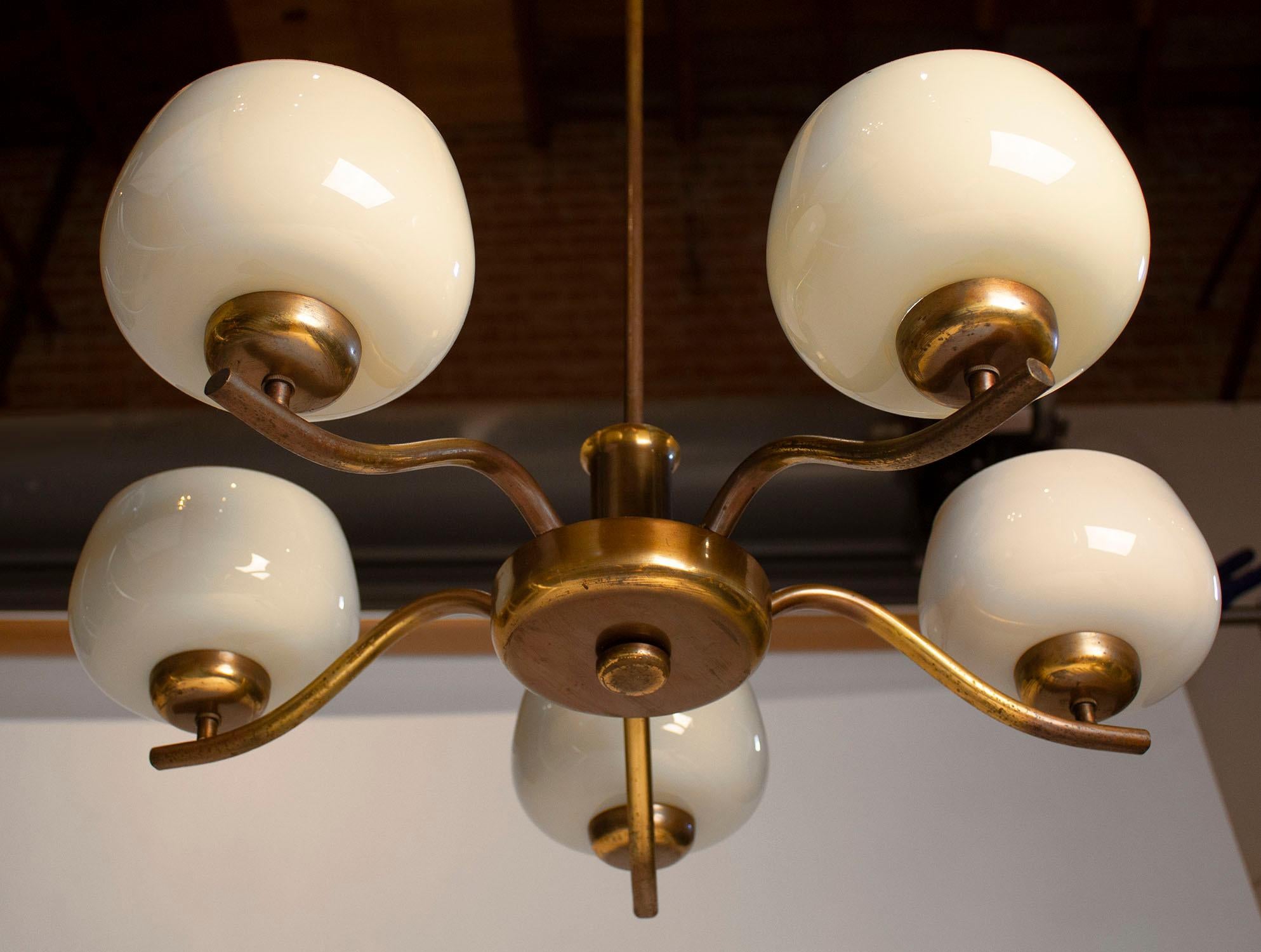 Blown glass and brass chandelier designed by Paavo Tynell for Taito Oy in the 1940s.

Each shade measures 6 diameter x 3.5 height
