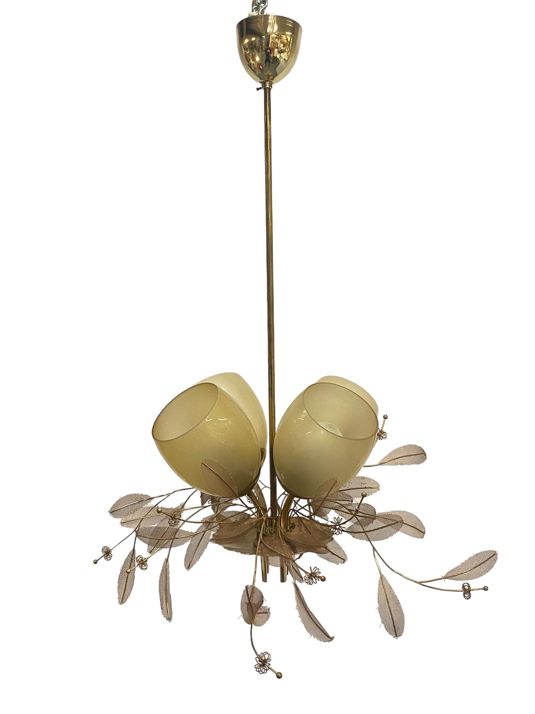 The absolutely beautiful and classic 9029 chandelier designed by Paavo Tynell and manufactured by Taito Oy in Finland in the 1950s. The model 9029 comes in various different sizes, this particular one is the one with four shades. Some refer to the