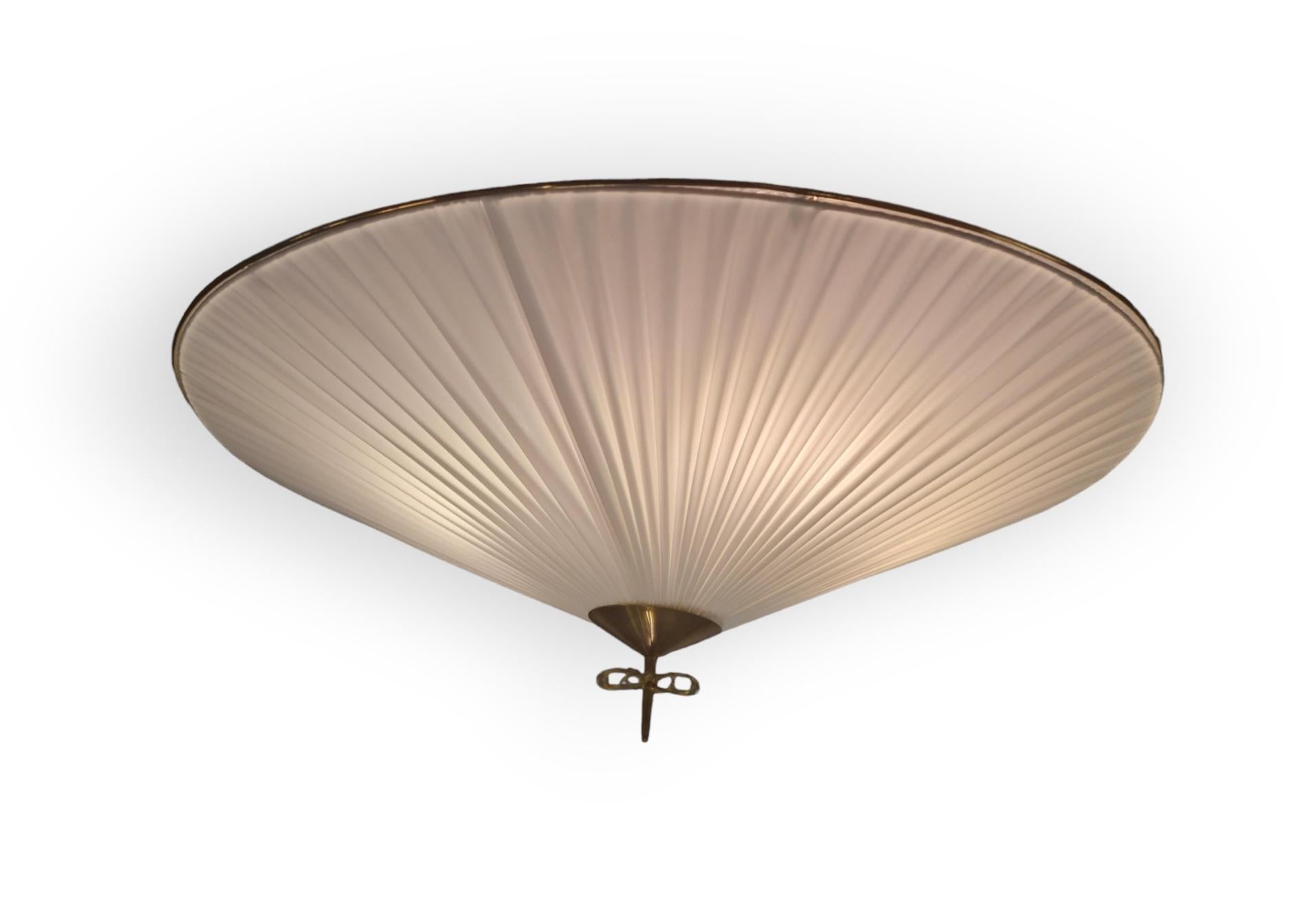 This faboulus ceiling lamp by Paavo Tynell is exceptionally large. It's almost 1 meter in diameter.

We feel as such it suits any room, be it a living room or large bedroom or a hallway. 

This model can be in a different number of shade options