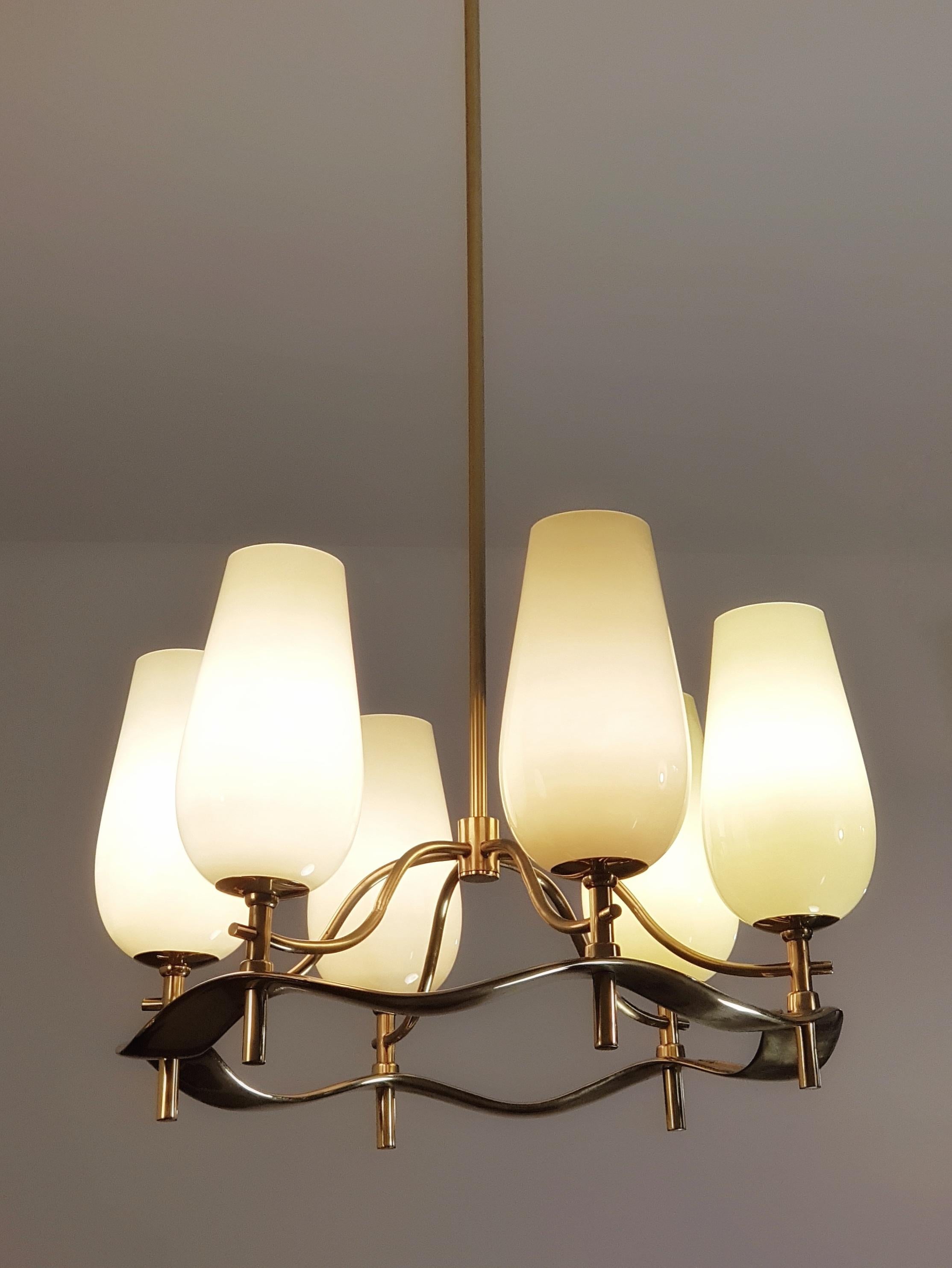 A beautiful sculptural chandelier commissioned for a private household in Tampere in the late 1940s. Some versions of this lamp have been seen before, but rarely with full brass as usually the lower cast brass ring is supported by the electric