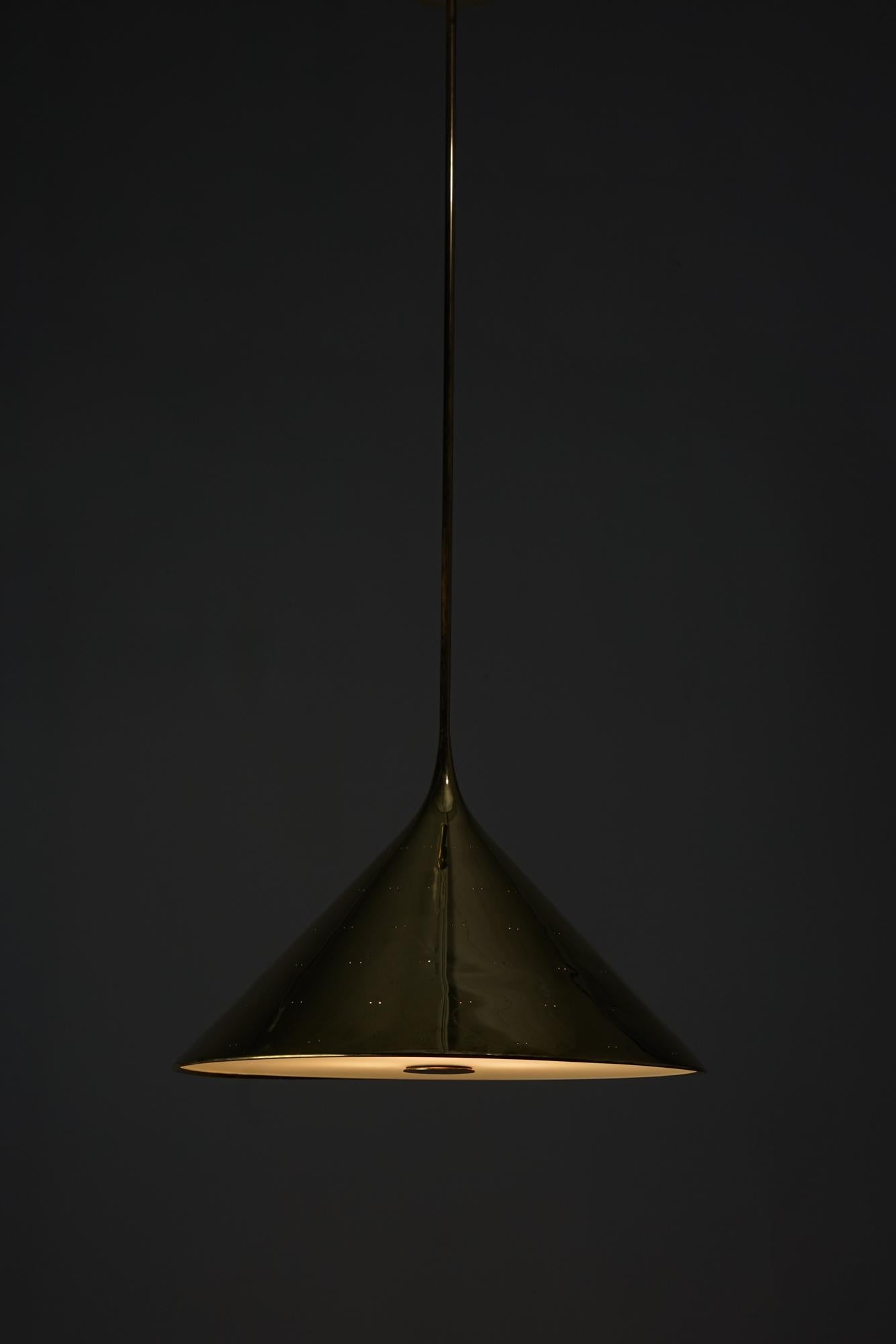 Exceptionally rare pendant by Paavo Tynell. Custom ordered model for the University of Economics in Helsinki. Model created circa 1950. Brass and glass. Good condition with wear consistent with age and use.

The way the light filters through the