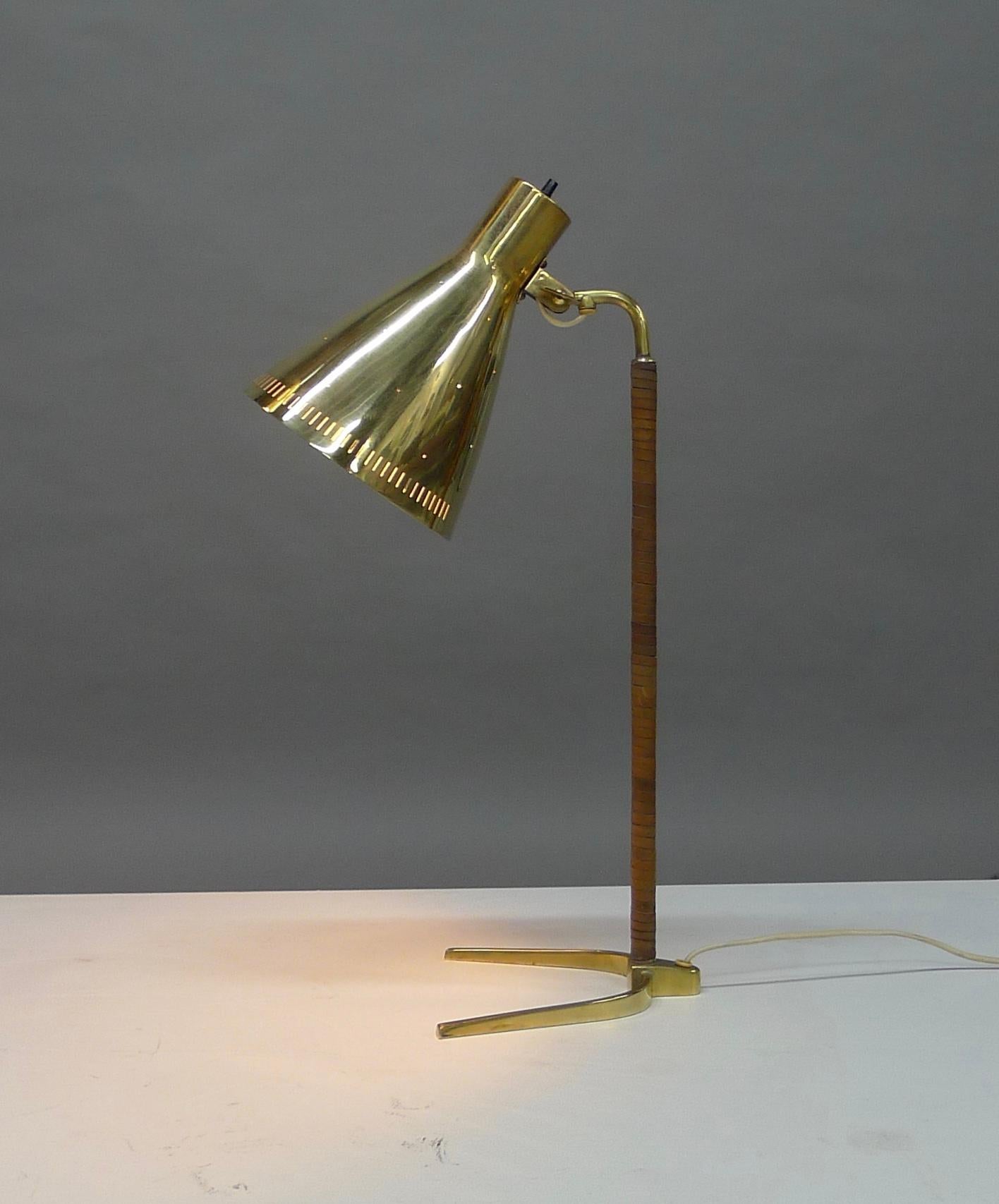 Paavo Tynell , Finland . Rare version of the 9224 desk lamp featuring a perforated shade so that light is subtely diffused through many tiny holes . Brass structure  with leather wrapping . The lamp is known as the 