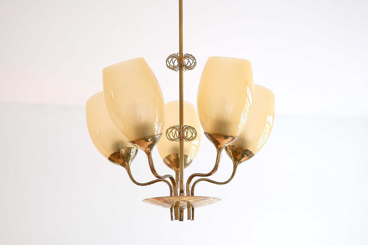 This five-glass chandelier was designed by Paavo Tynell and produced by Taito Oy in Finland in 1949. Paavo Tynell was responsible for designing the lighting for the hospital in Kuopio, which can be viewed in the sketches from the Taito archives (as