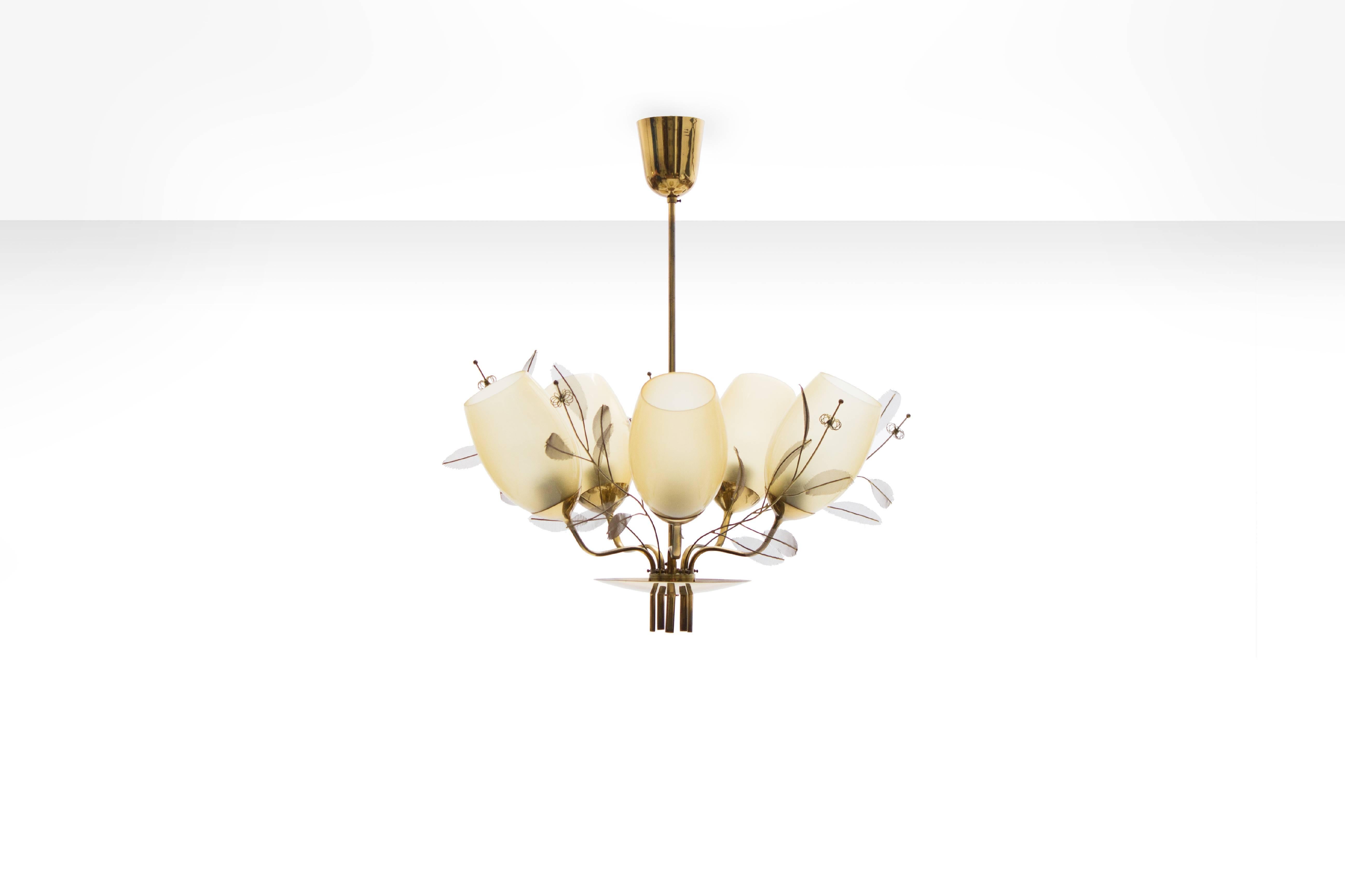 Paavo Tynell five-arm chandelier for Taito Oy - Model 9029/5, Finland 1950s

This chandelier from the 'Concerto' series, also known as the “Bridal Bouquet” chandelier, consists out of five lampshades in opaline glass on a brass frame decorated
