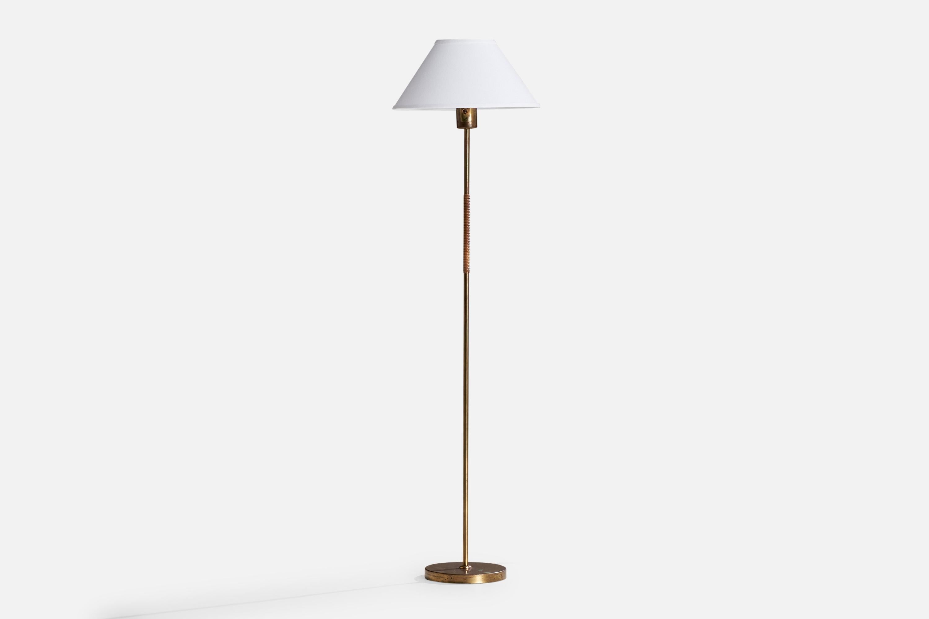 A brass, rattan and white fabric glass floor lamp designed by Paavo Tynell and produced by Idman, Finland, 1950s.

Dimensions of Lamp with Shade (inches): 59.5“ H x 16“ Diameter

Bulb Specifications: E-26 Bulb

Number of Sockets (per fixture):