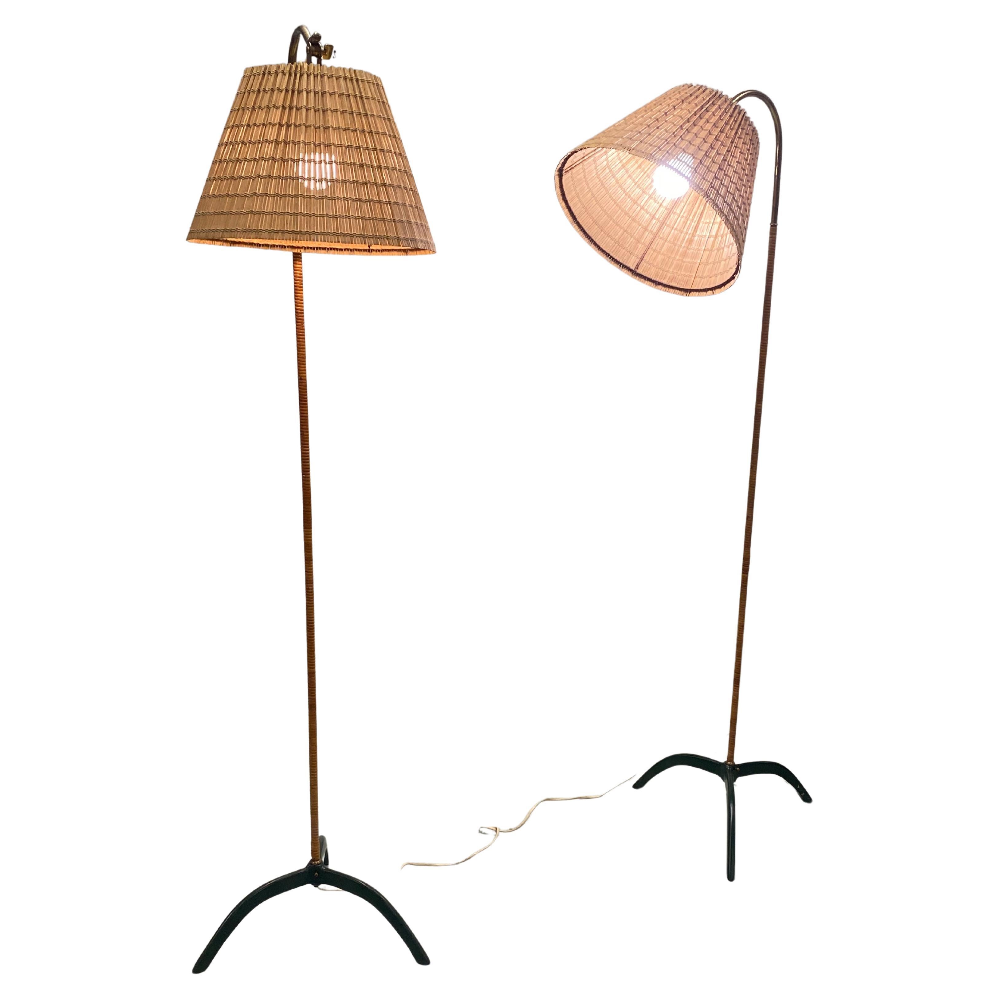 Paavo Tynell (1890-1973) original floor lamps model 9609, manufactured by Taito Oy in the 1950s.  A beautiful pair if floor lamps with a lacquered metal and rattan stem. All original parts excluding the beautiful renewed rattan shades. The bottom