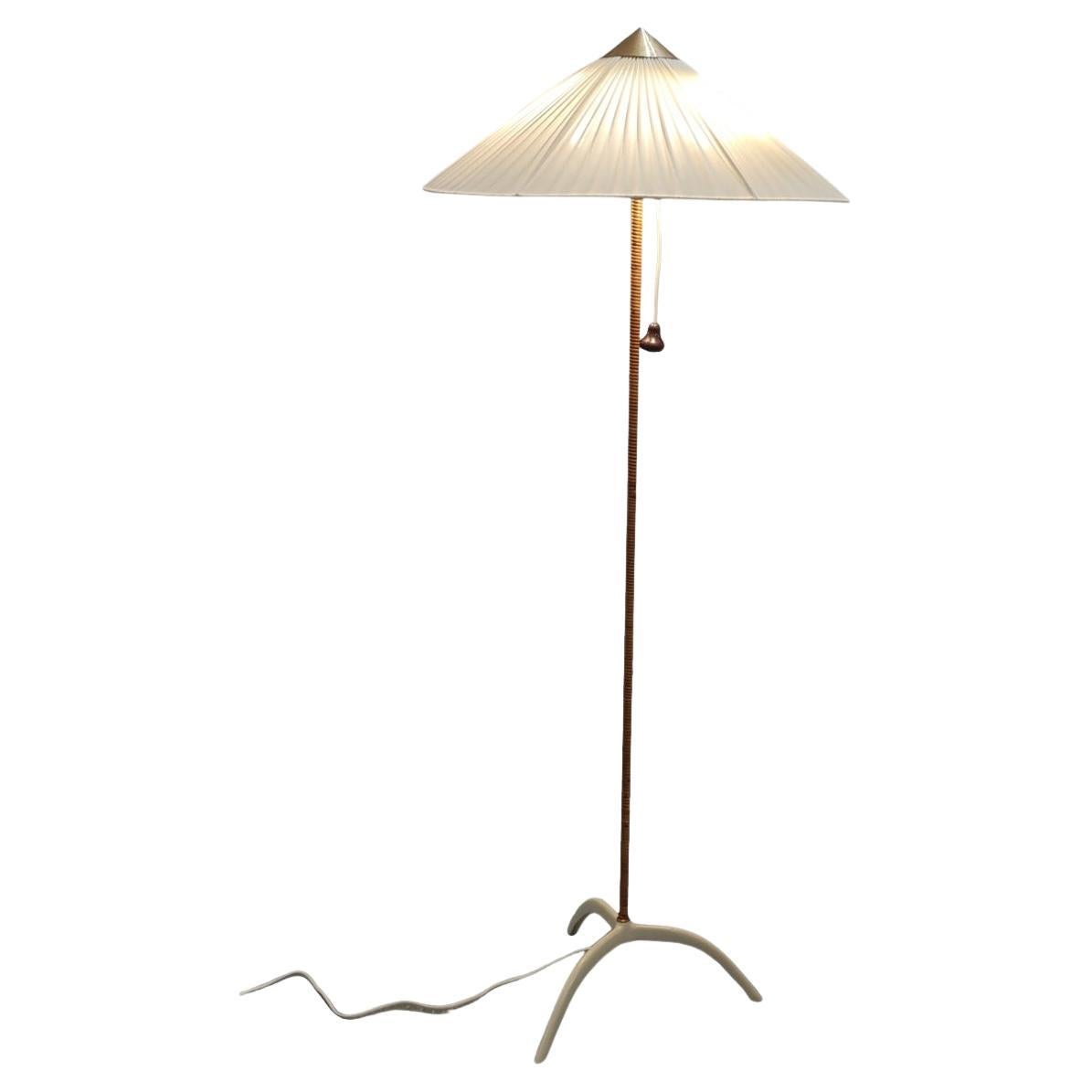 Paavo Tynell (1890-1973) original floor lamp model. 9615, manufactured by Taito Oy in the 1950s.  A beautiful floor lamp with a lacquered metal and rattan stem. All original parts excluding the beautiful fabric shade. The bottom part (often called