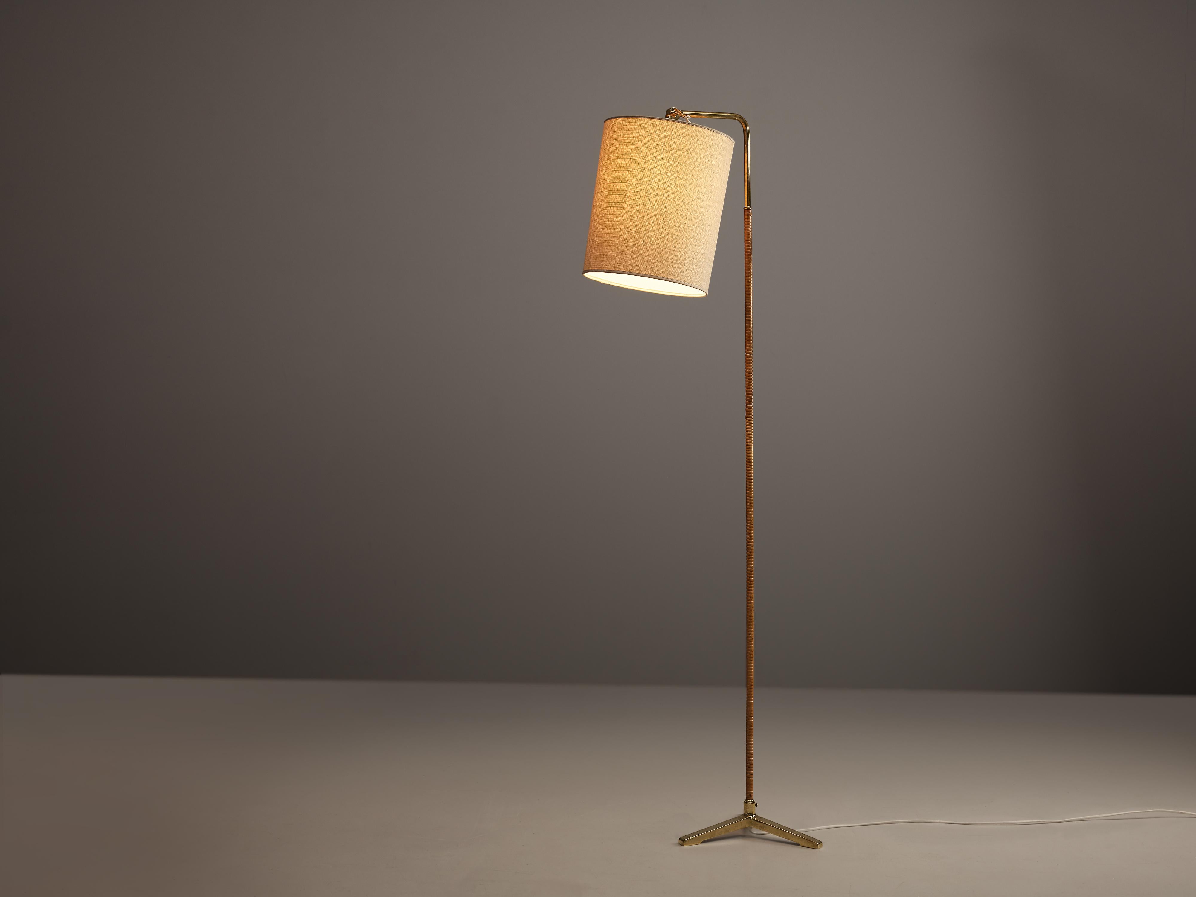 Paavo Tynell for Taito, floor lamp model 9631, brass, cane, cloth, Finland, 1950s

Elegant floor lamp by Finish master of lights Paavo Tynell. This admirable floor lamp stands on a delicate tripod in brass from which a thin stem with a cane surface