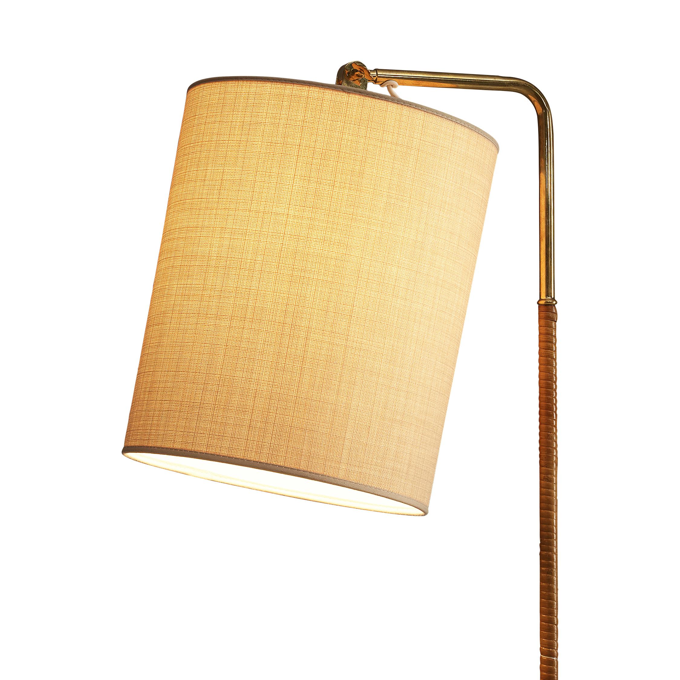 Paavo Tynell for Taito, floor lamp model 9631, brass, cane, cloth, Finland, 1950s

Elegant floor lamp by Finish master of lights Paavo Tynell. This admirable floor lamp stands on a delicate tripod in brass from which a thin stem with a cane surface