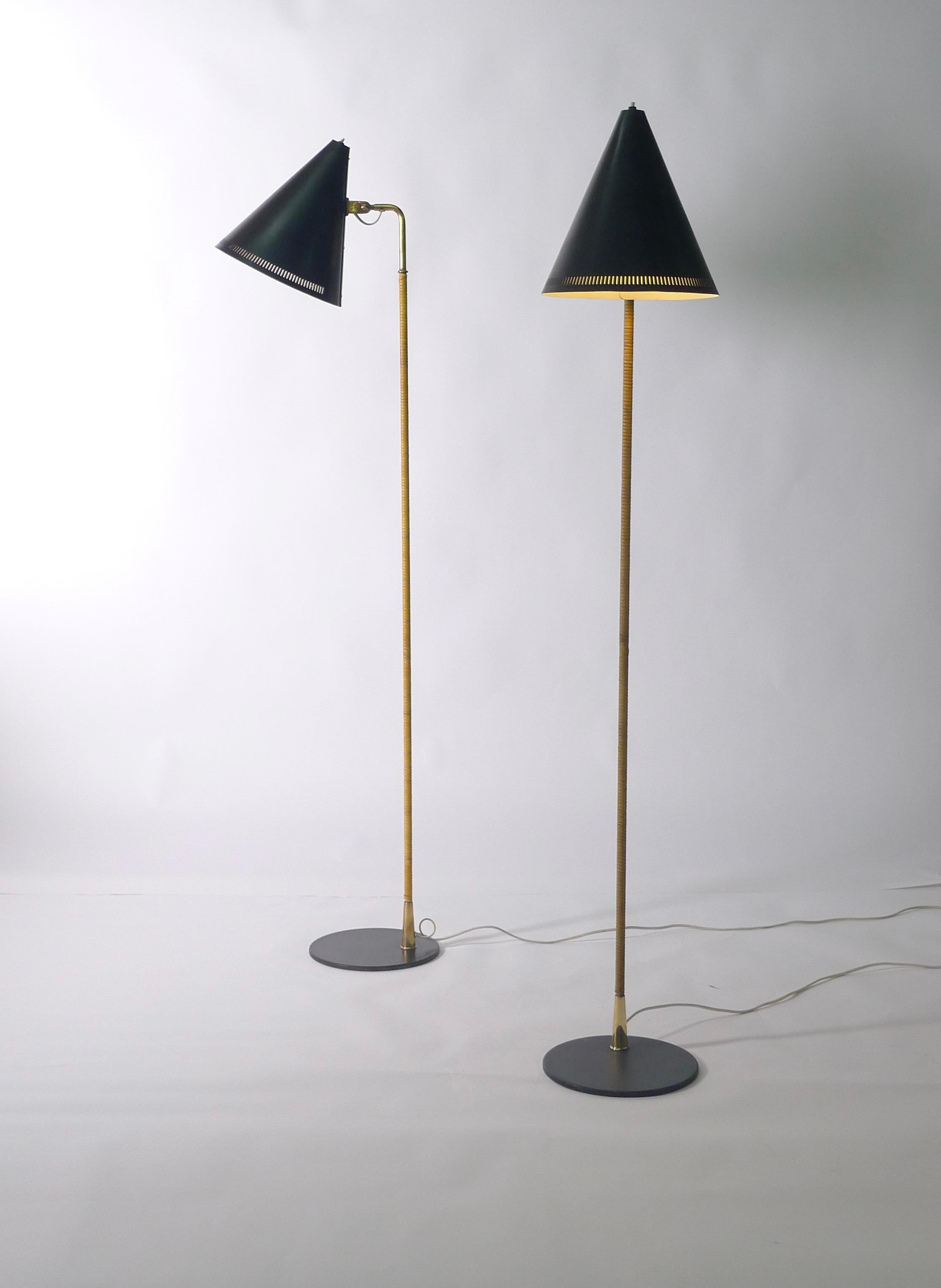 Paavo Tynell floor lamp, model K10-10-10, for Idman, Finland

Price is per lamp (2 available). 

Perforated black enamelled shade on rattan covered brass shaft with adjustable lever to alter height and direction. Bearing the Idman stamped