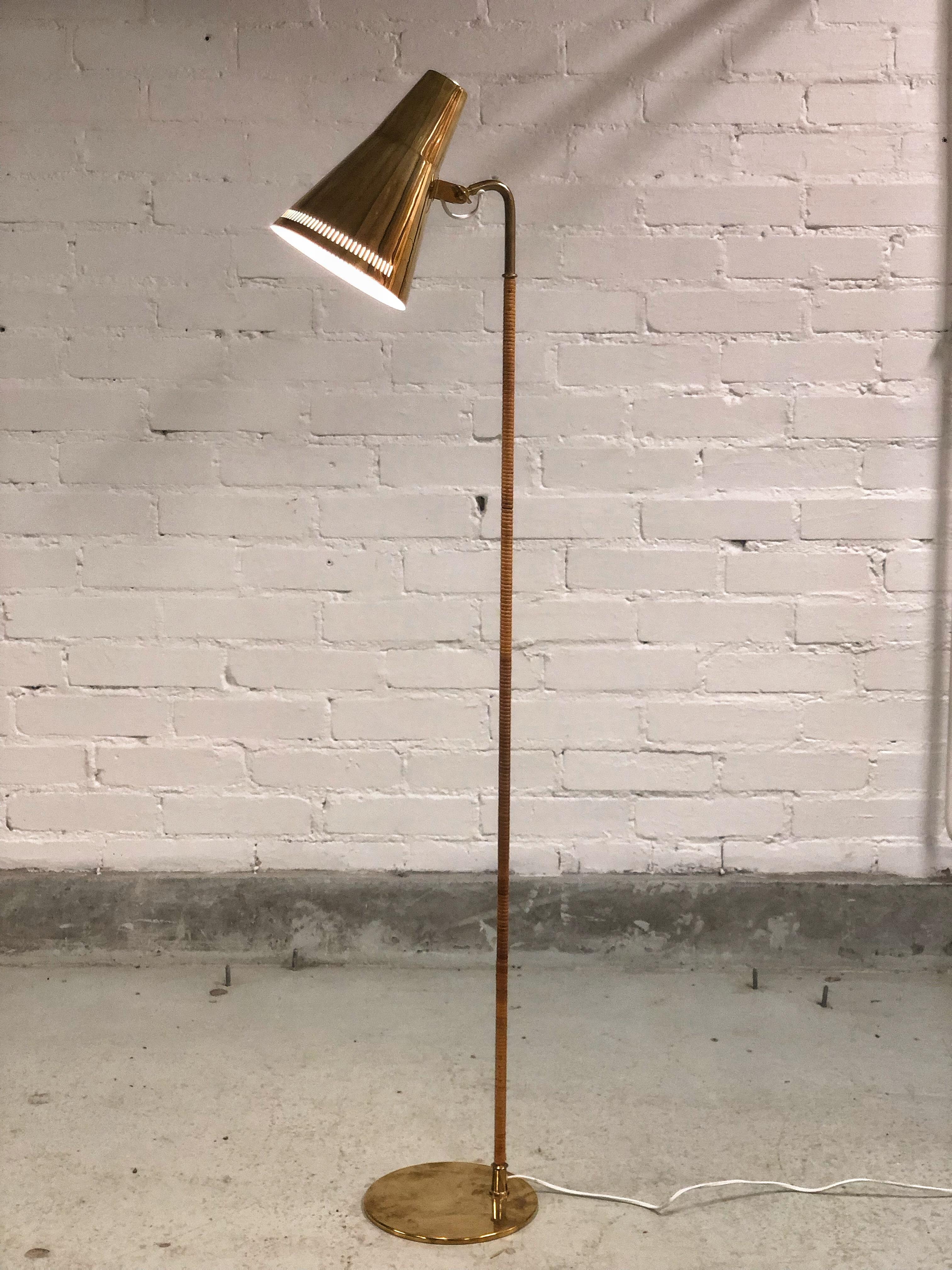 A gracefully slim floor lamp with a solid brass shade and a rattan wrapped stem. These lamps harmoniously combine the coldness of brass and natural warmth of rattan to create a design that can enhance the finest of interiors, private or public.

We
