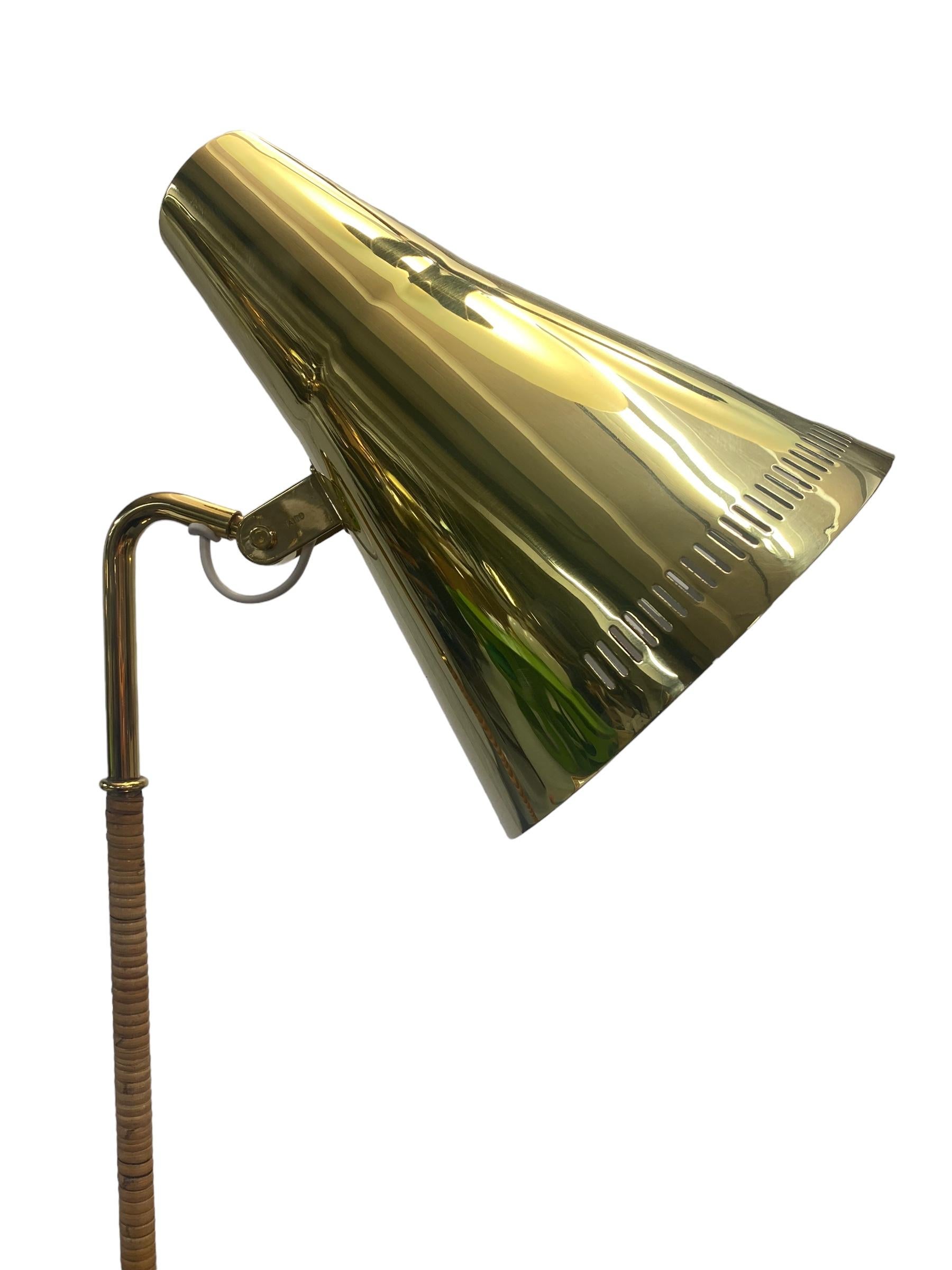 A gracefully slim floor lamp with a solid brass shade and a rattan wrapped stem. This lamp harmoniously combines the coldness of brass and natural warmth of rattan to create a design that can enhance the finest of interiors, private or public.

We