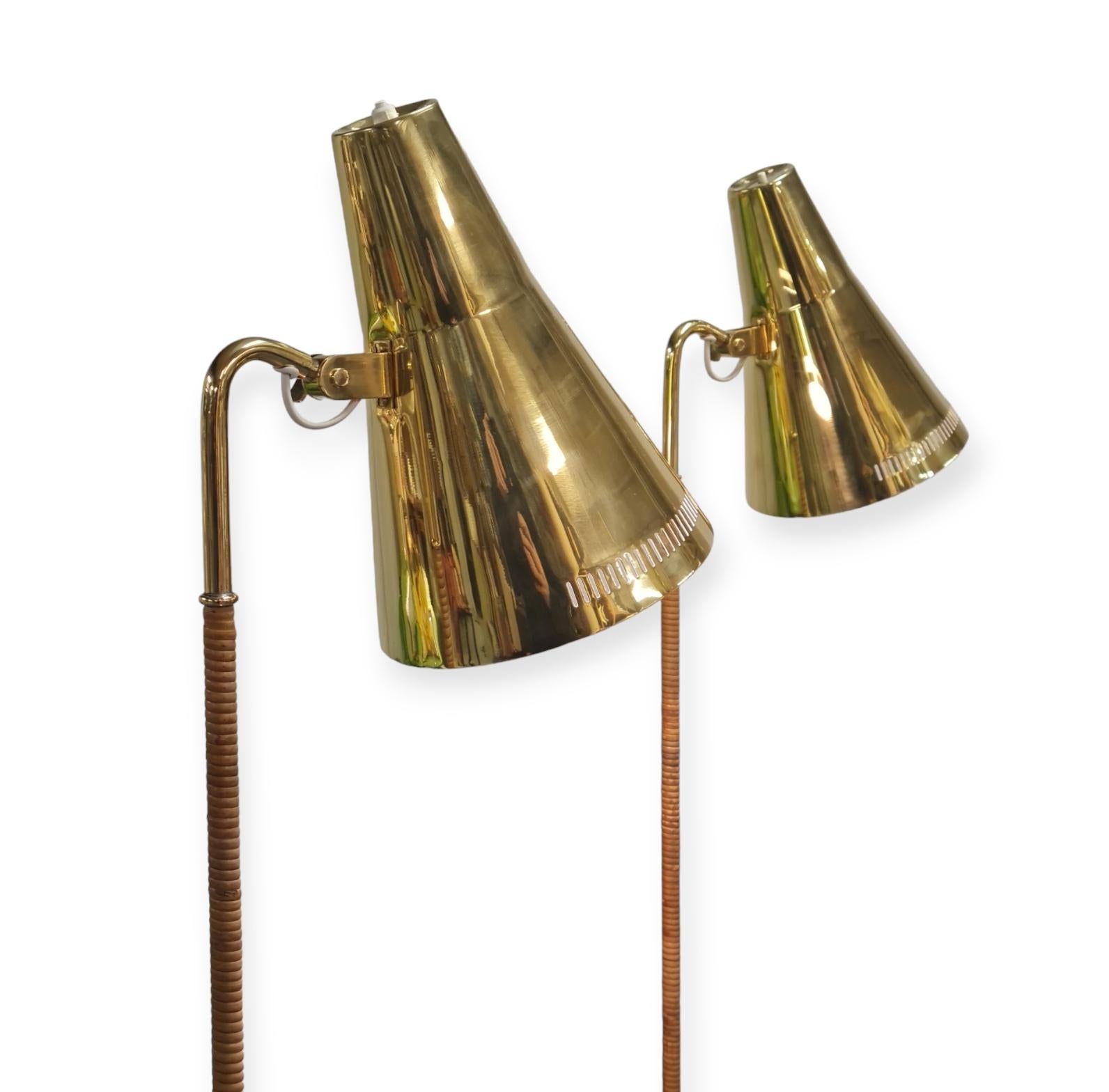 A pair of gracefully slim floor lamps with a solid brass shade and a rattan wrapped stem. These lamps harmoniously combine the coldness of brass and natural warmth of rattan to create a design that can enhance the finest of interiors, private or