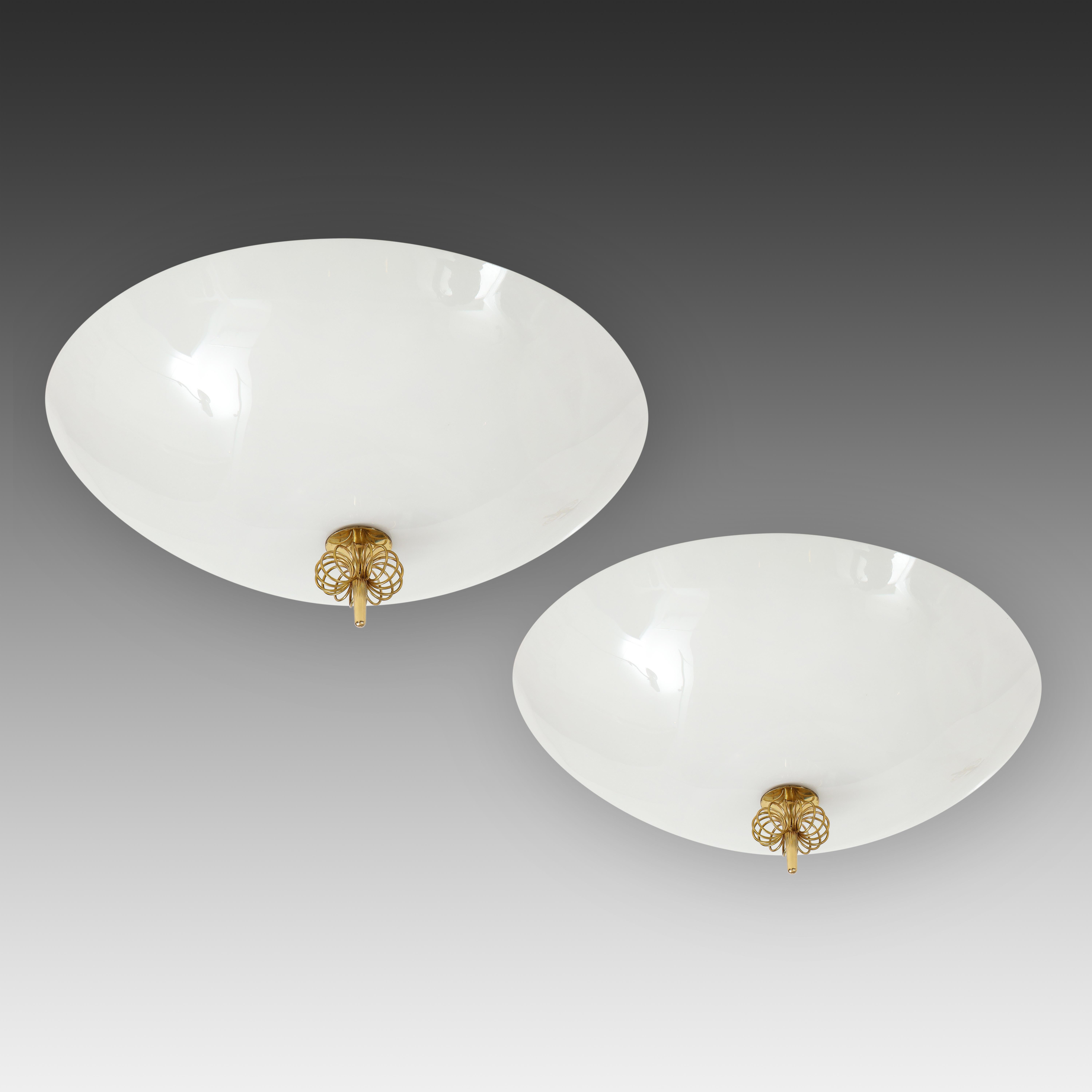 Paavo Tynell for Idman Oy elegant pair of flush mount ceiling lights with opaline glass dish shades with trademark central brass spiral decorations. Impressed with manufacturer's mark 