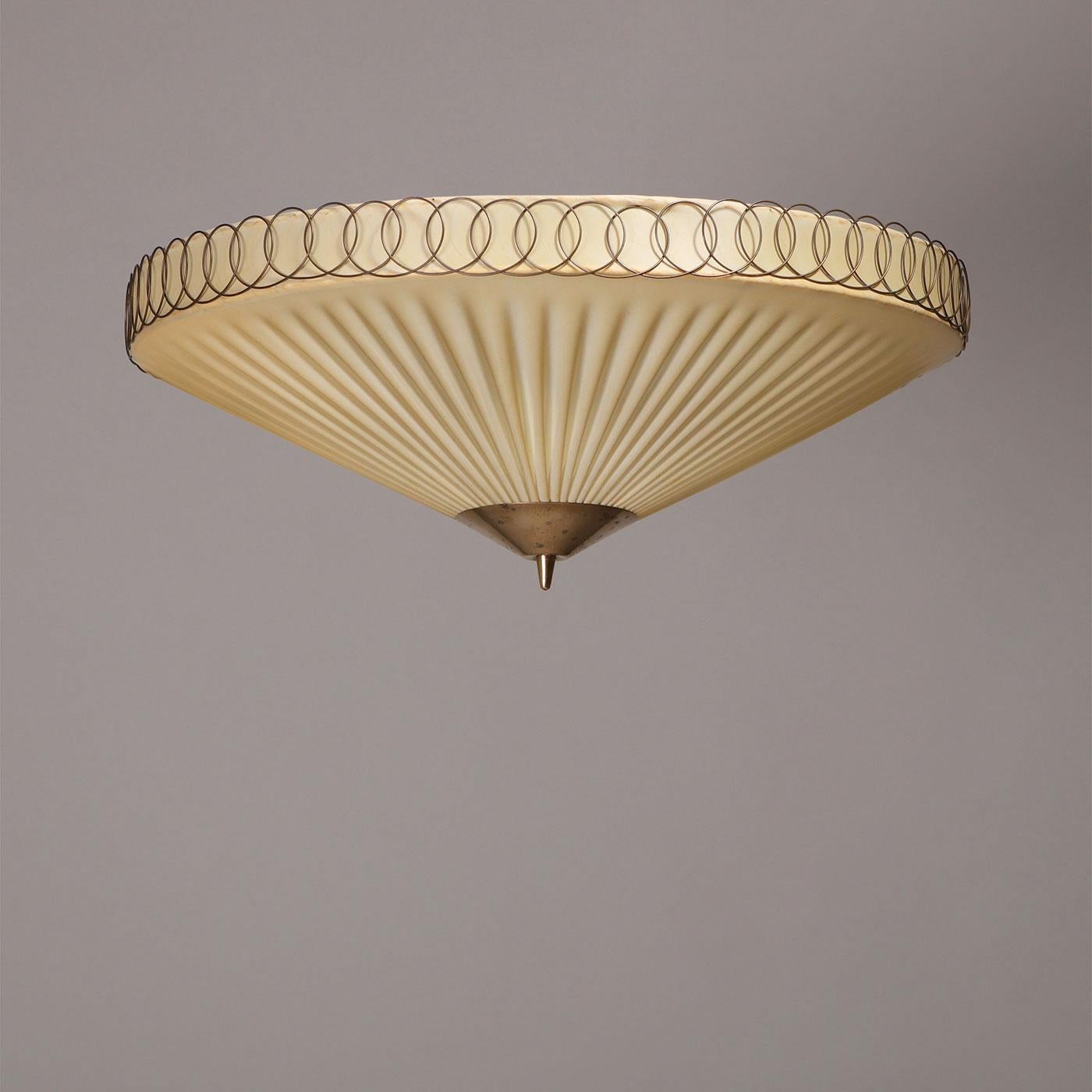 Paavo Tynell for Idman, flush mount ceiling lamp model ‘20399’, plastic lampshade, brass, Finland, 1950s.

Flush mount ceiling lamp, model ‘20399’, designed by Paavo Tynell (1890-1973). Manufactured by Idman in the 1950s. Made of pleated plastic