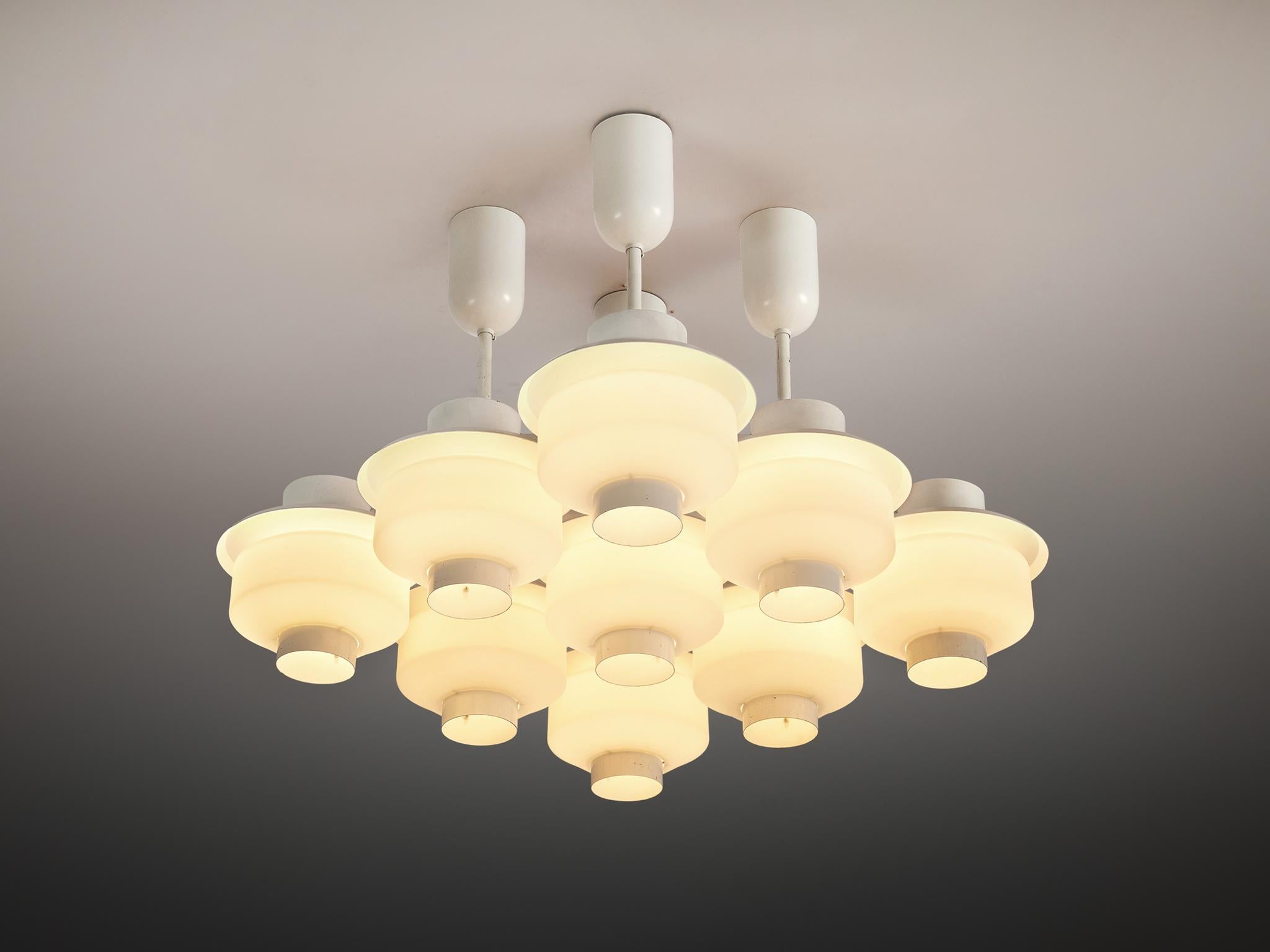 Paavo Tynell for Idman, chandelier, lacquered steel, opaline glass, Finland, 1950s

Striking chandelier by Paavo Tynell, originating from the central railway station in Helsinki. The chandelier consists of nine lightbulbs in a geometric shape. Round