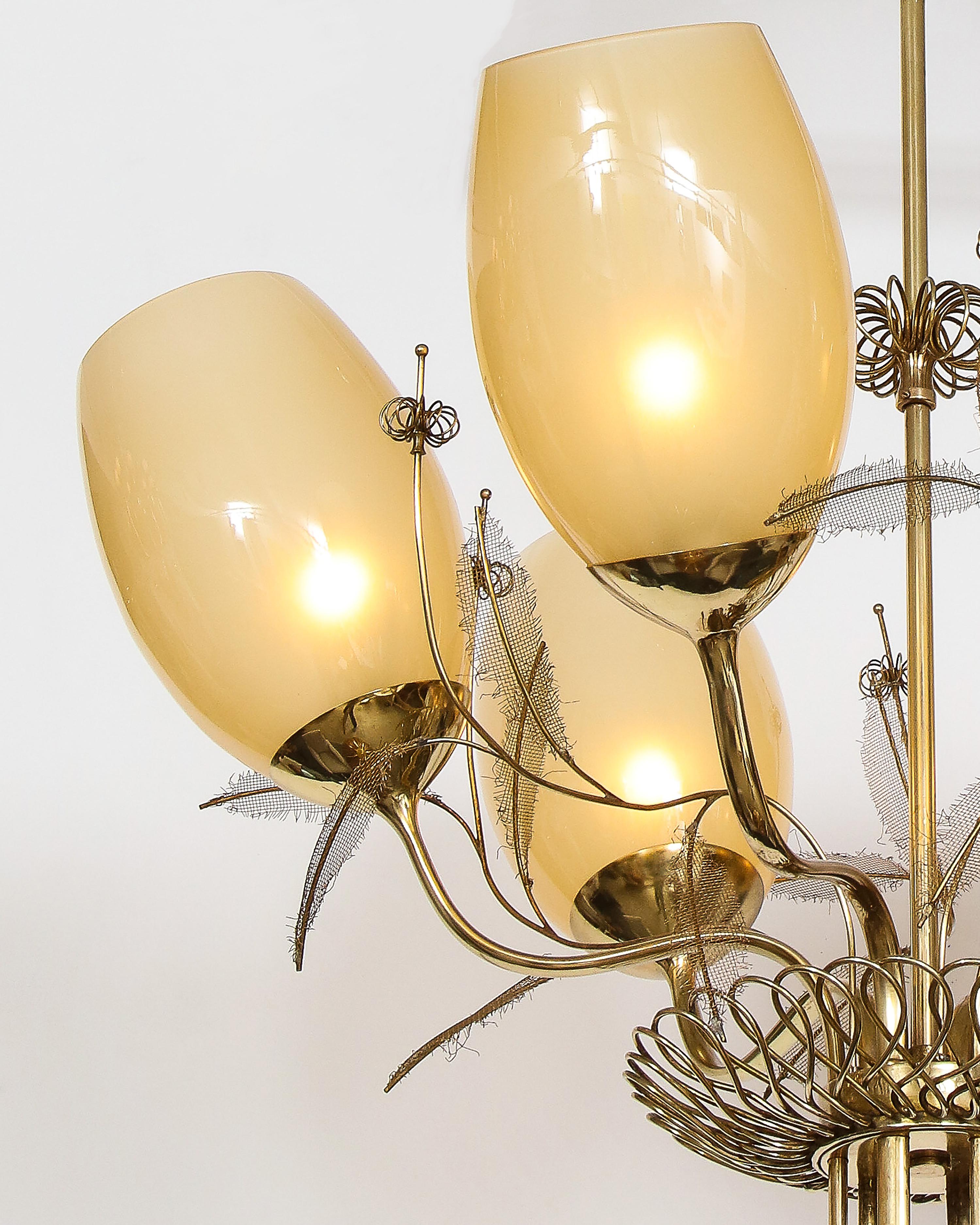Paavo Tynell for Taito Oy rare and elegant chandelier or ceiling light model 9029/6 with beautifully ornate brass structure holding 6 amber cased glass shades, brass spiral rosette accents and mesh leaf decorations, and original canopy. This