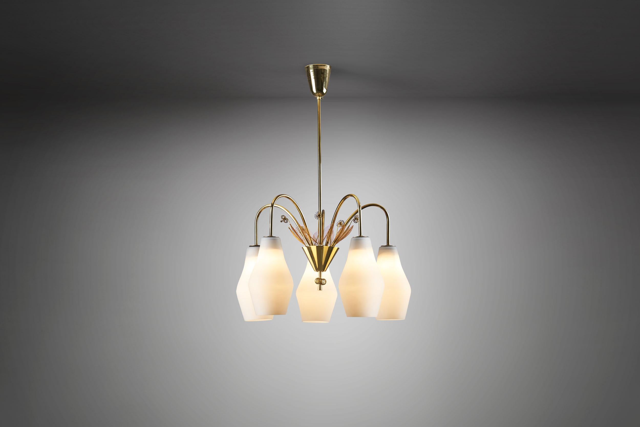 This beautiful brass and glass chandelier belongs to the legendary Finnish lighting designer, Paavo Tynell’s more decorated models of the 1950s. This model is quite rare in Tynell’s repertoire, and could only be compared to a custom commission for a