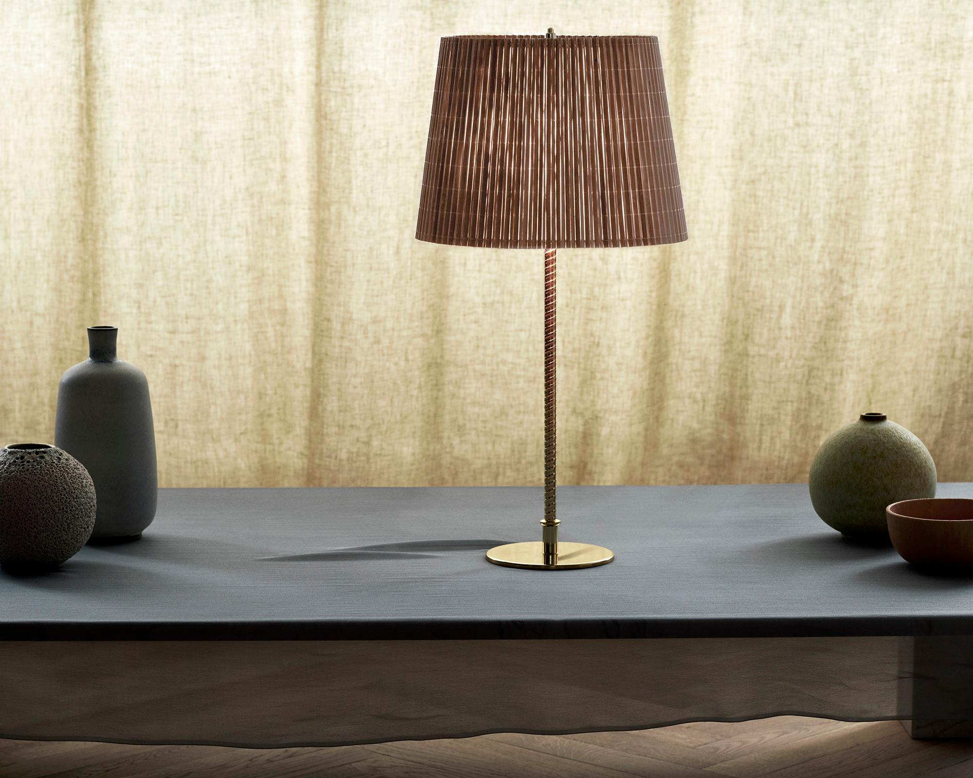 Paavo Tynell Model 9205 Bamboo and Brass Table Lamp for GUBI.

Originally designed by Paavo Tynell around 1950, this authorized GUBI re-edition is executed in brass with a hand-sewn bamboo or handmade canvas shade. The brass stem is milled with a