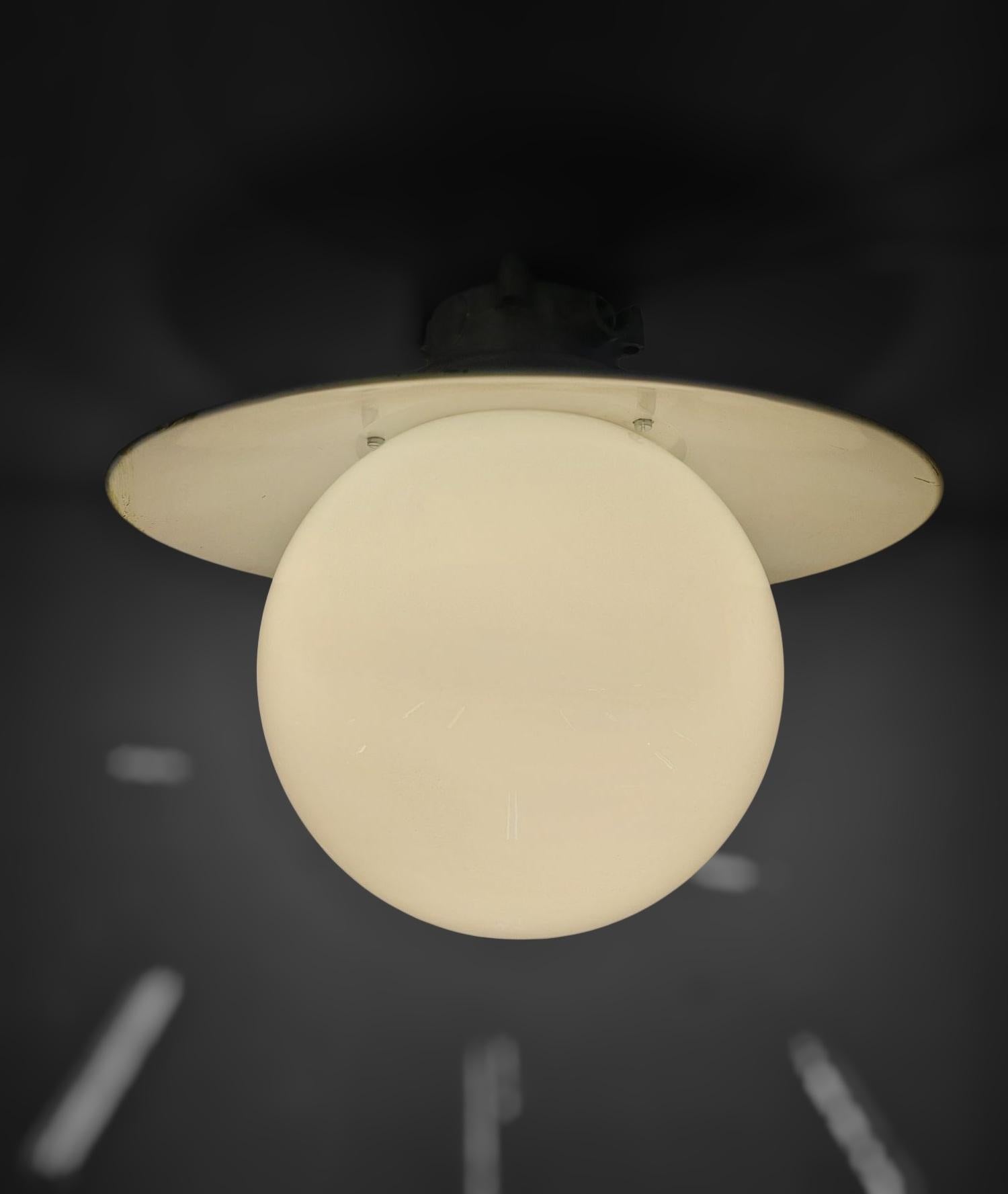 An industrial style Paavo Tynell outdoor / indoor lamp model H9-100. The lamp has a beautiful and original white / gray colour metal shade that is easy to integrate in any interior or exterior combinded with white opaline glass ball shades. The lamp