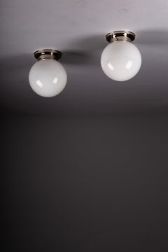 Paavo Tynell, pair of 1930's opaline glass flush mount lamps for Idman Oy