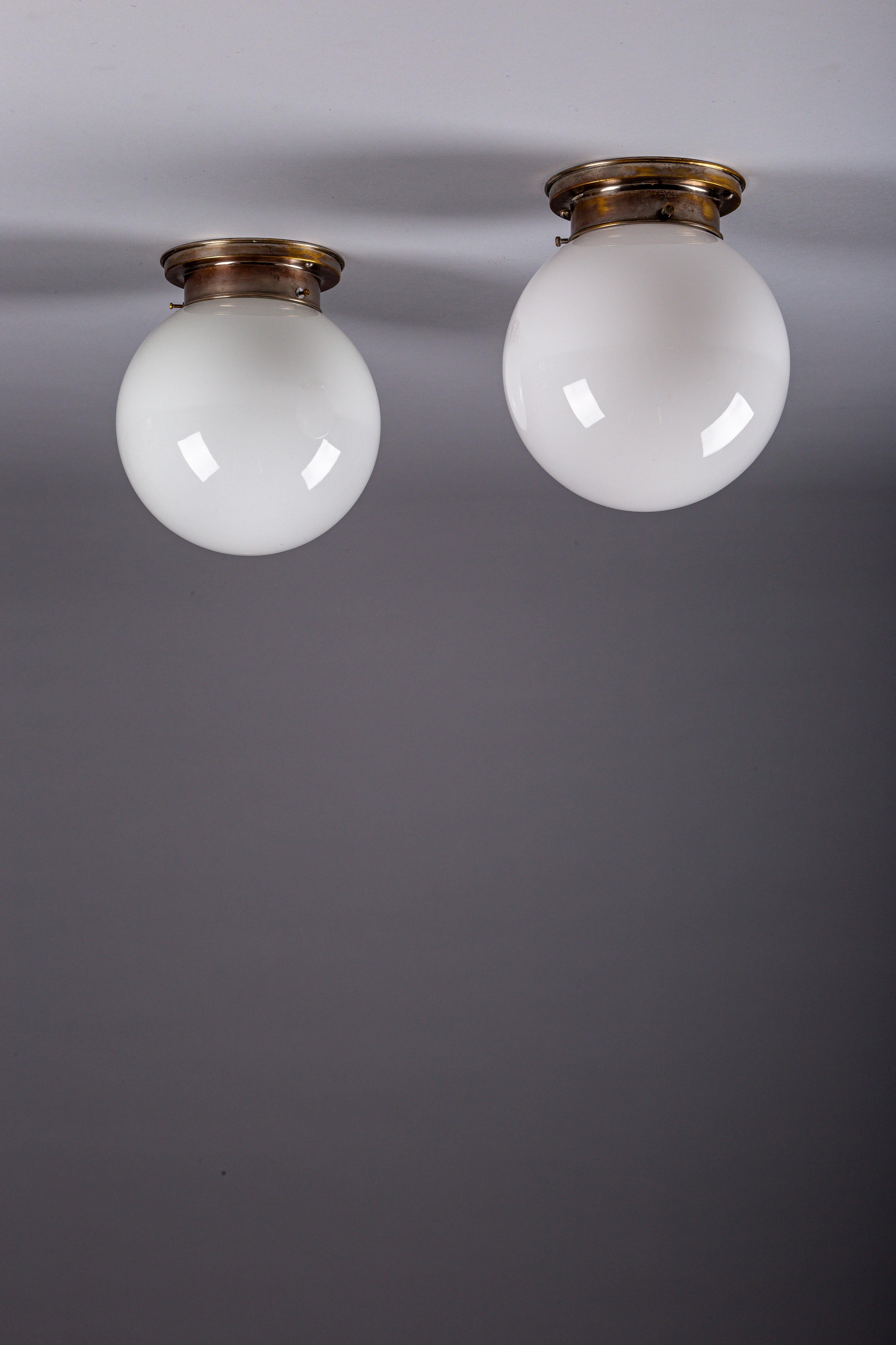 Finnish Paavo Tynell, pair of 1930's opaline glass flush mount lamps for Idman Oy