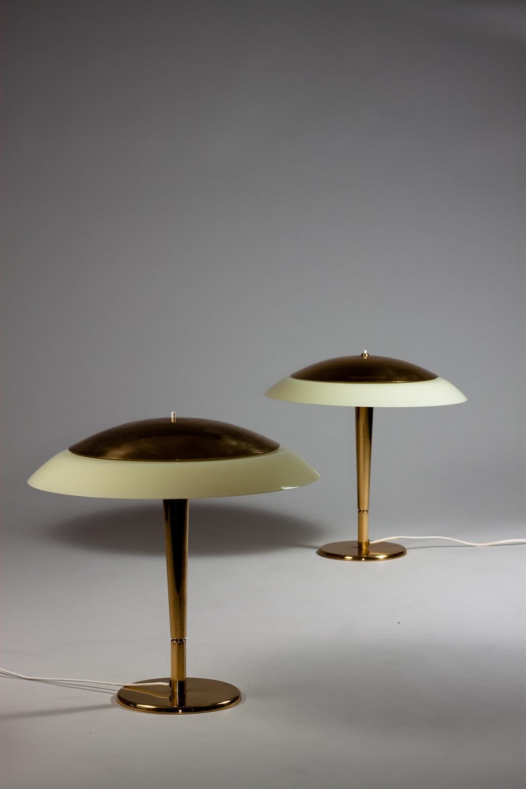 Introducing a pair of stunning brass desk lamps by Paavo Tynell, manufactured by Taito Oy in the 1940s and 1950s. These vintage lamps have a timeless design that still looks as sleek and modern today as it did over 70 years ago. The brass finish